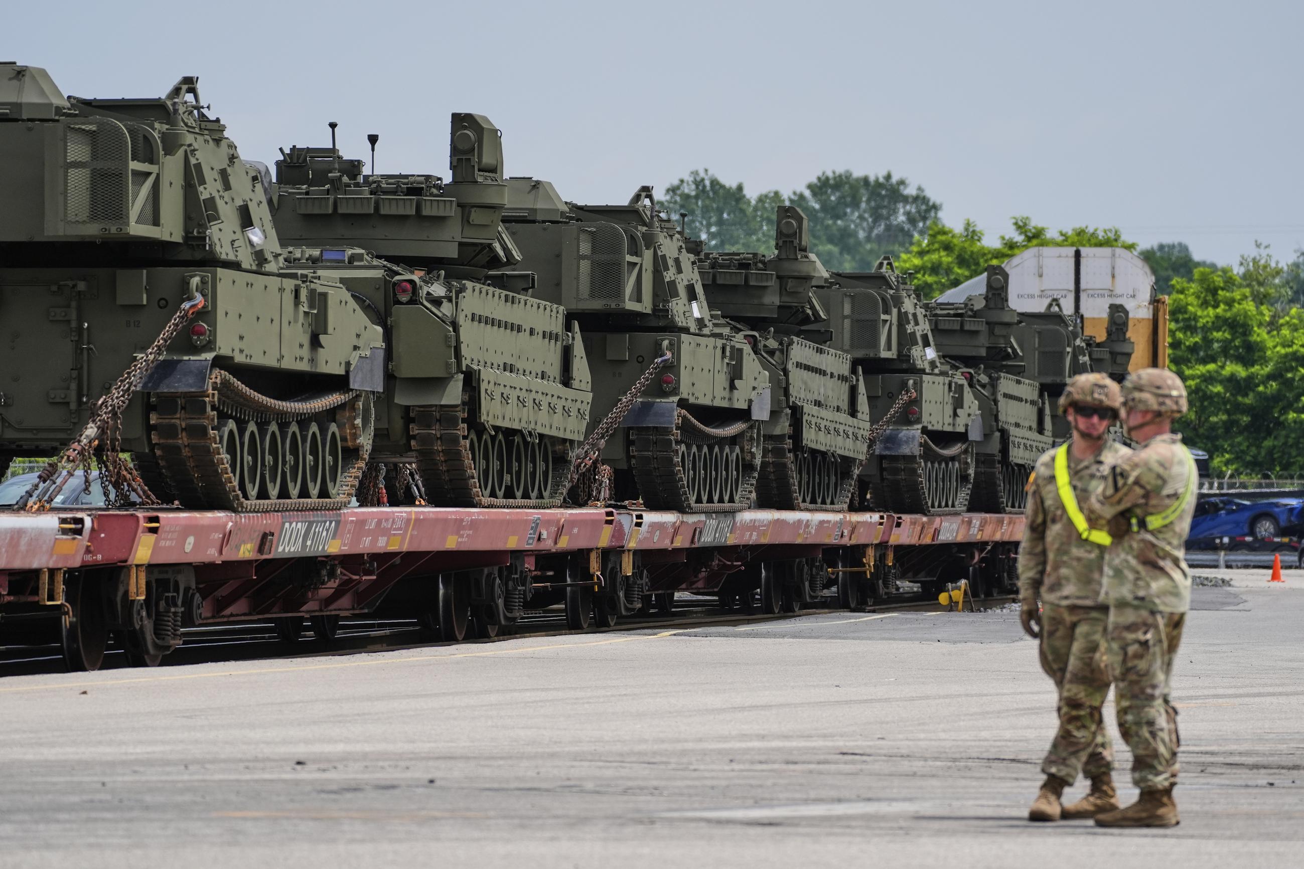 U.S. Army personnel watch as tanks and other military vehicles are transported via locomotive at the CSX railroad yard in Jessup, Md., Monday, June 9, 2025, ahead of an upcoming military parade commemorating the U.S. Army’s 250th anniversary and coinciding with Donald Trump’s 79th birthday. (AP Photo/Stephanie Scarbrough)