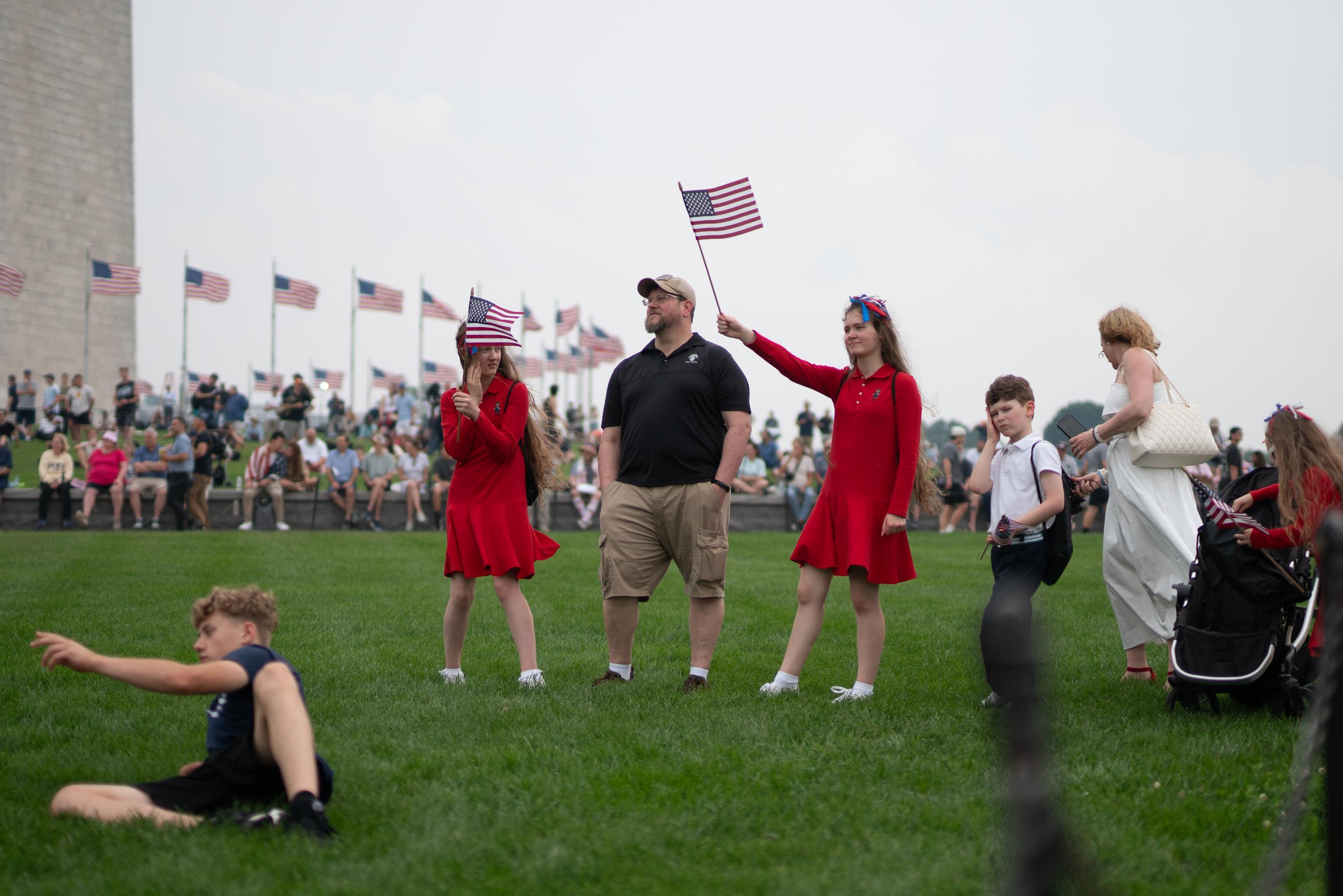 A group of parade attendees signal the start of the 250th Army Birthday Parade. June 15, 2025.