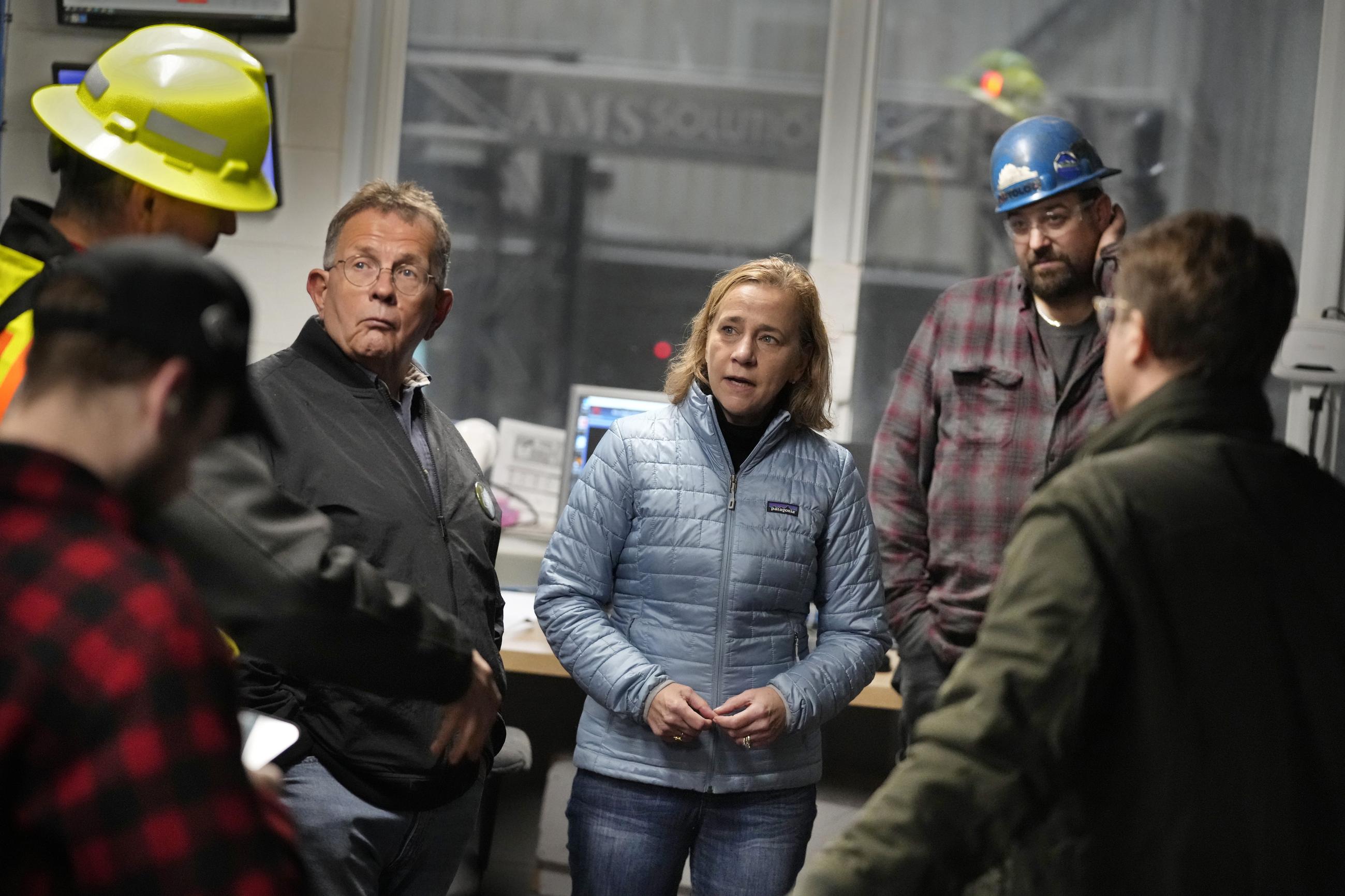 Joyce Craig, Democratic candidate for governor, talks with sawmill employees and local officials during a visit to the Milan Lumber mill, Wednesday, Oct. 16, 2024, in Milan, N.H. (AP Photo/Robert F. Bukaty)