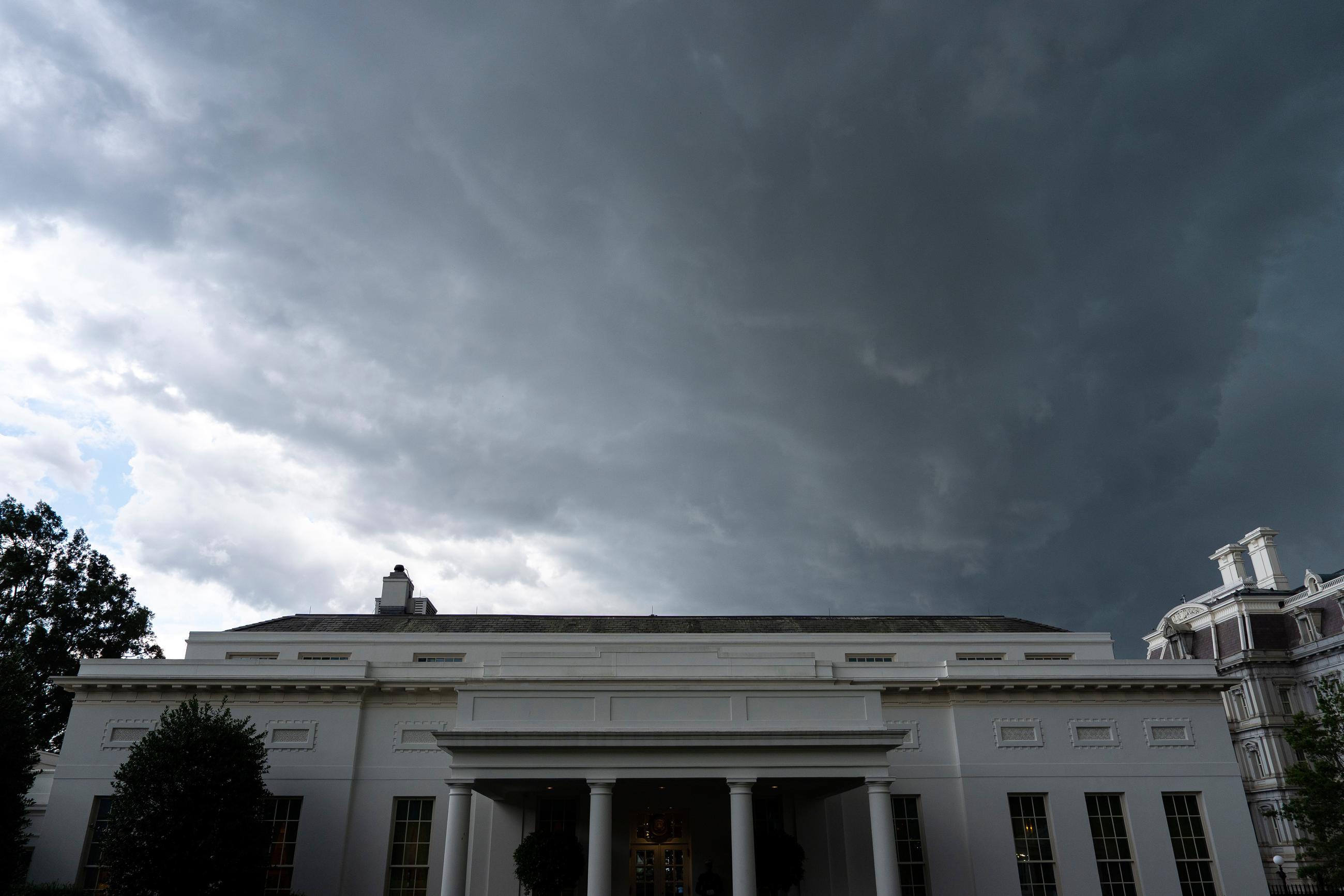 The dark clouds of an approaching thunderstorm move over the West Wing of the White House, Thursday, June 19, 2025, in Washington. (AP Photo/Alex Brandon)