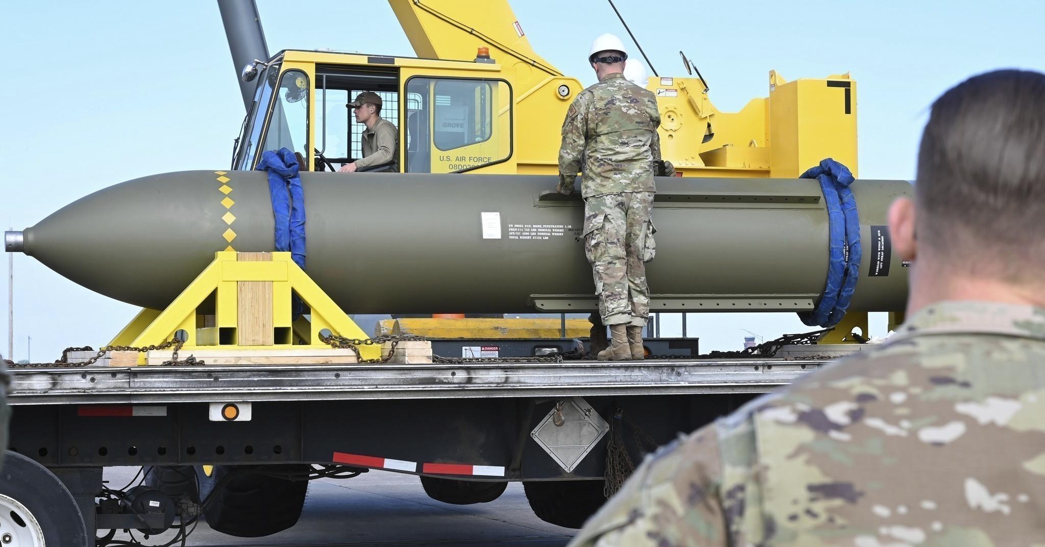 FILE - In this photo released by the U.S. Air Force in 2023, airmen look at a GBU-57, or the Massive Ordnance Penetrator bomb, at Whiteman Air Base in Missouri. (U.S. Air Force via AP, File)