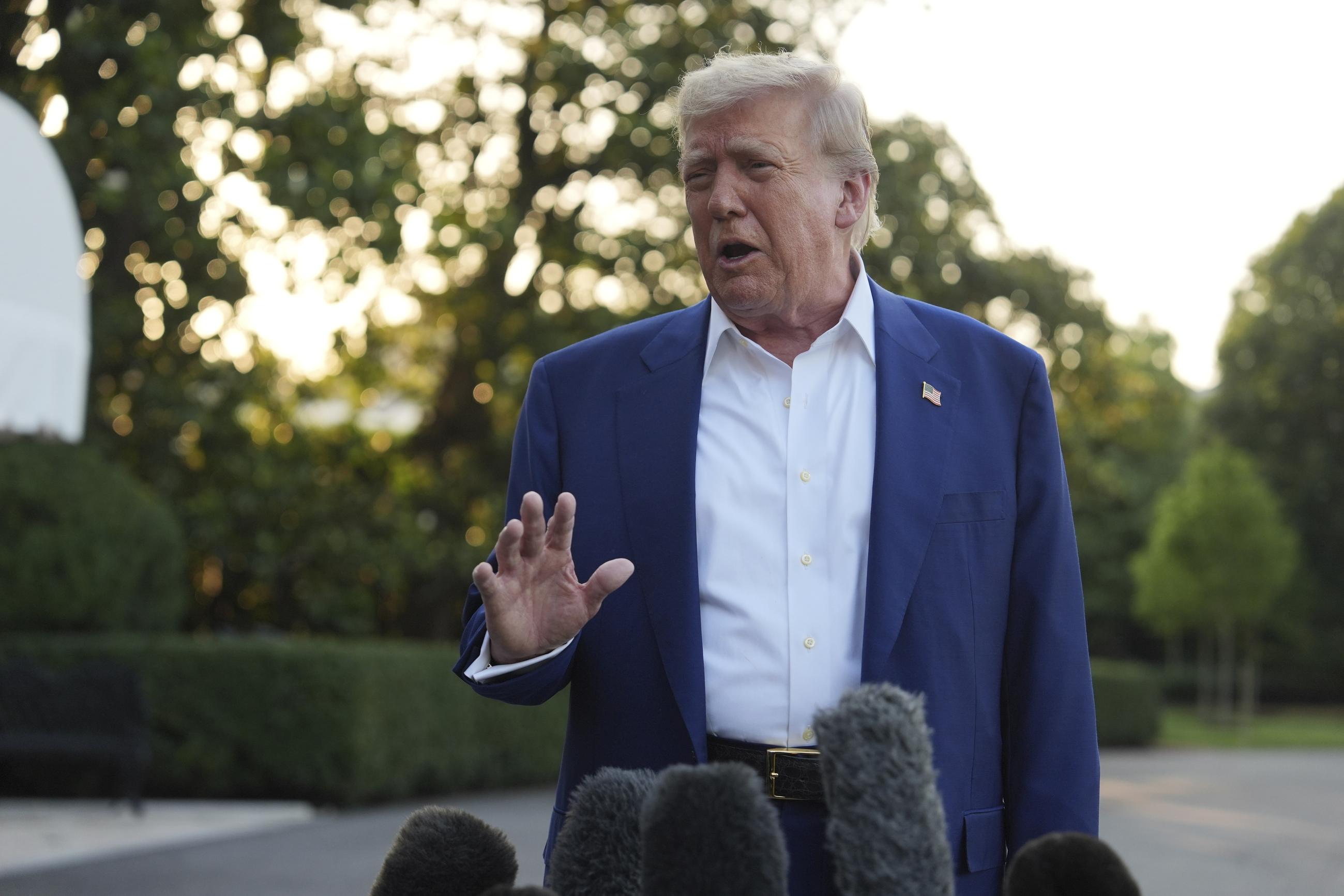 President Trump speaks with reporters before boarding Marine One on the South Lawn of the White House Tuesday. (AP Photo/Evan Vucci)