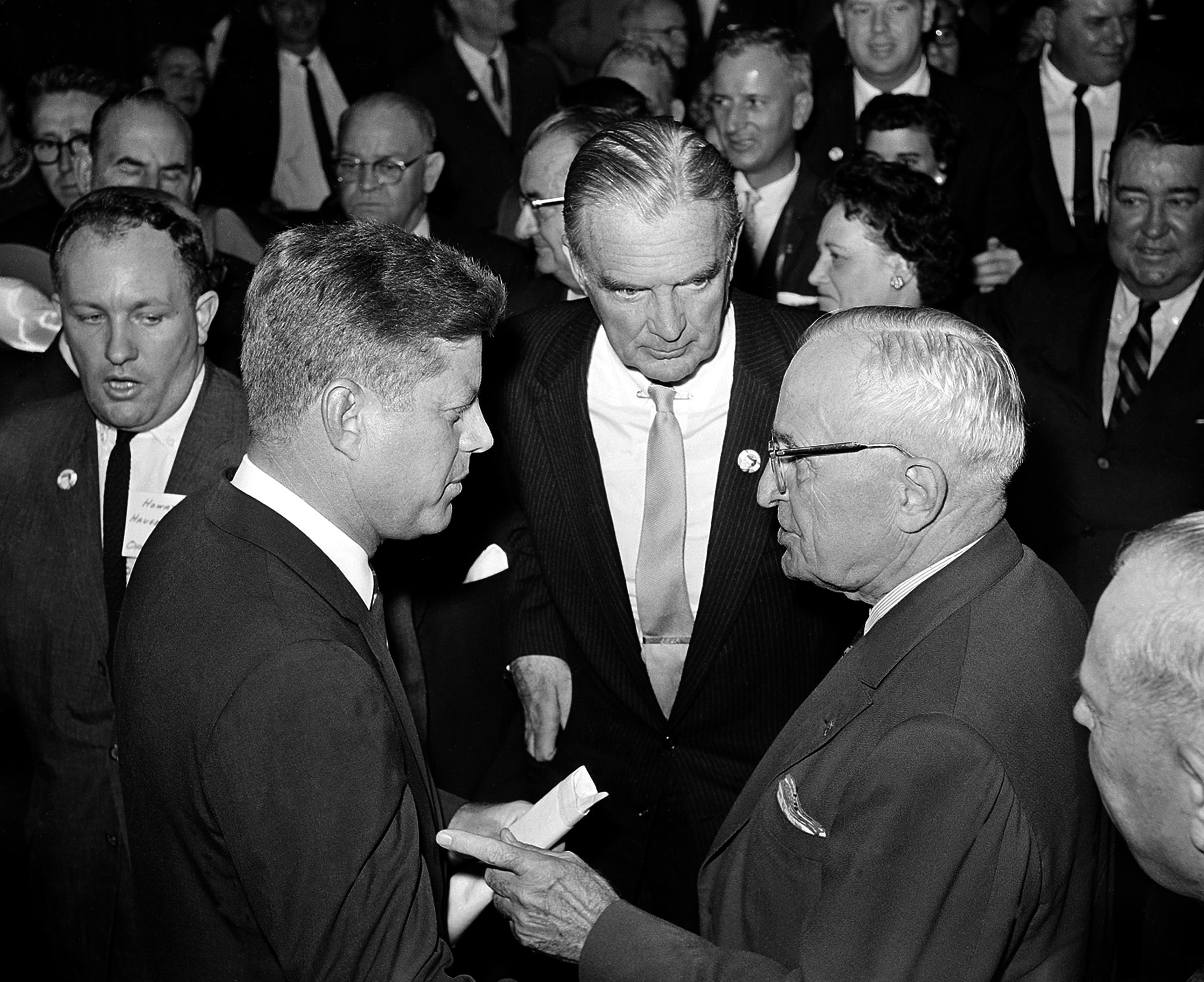 Sen. John F. Kennedy speaks to former President Harry Truman during the presidential campaign in 1960. (AP Photo)