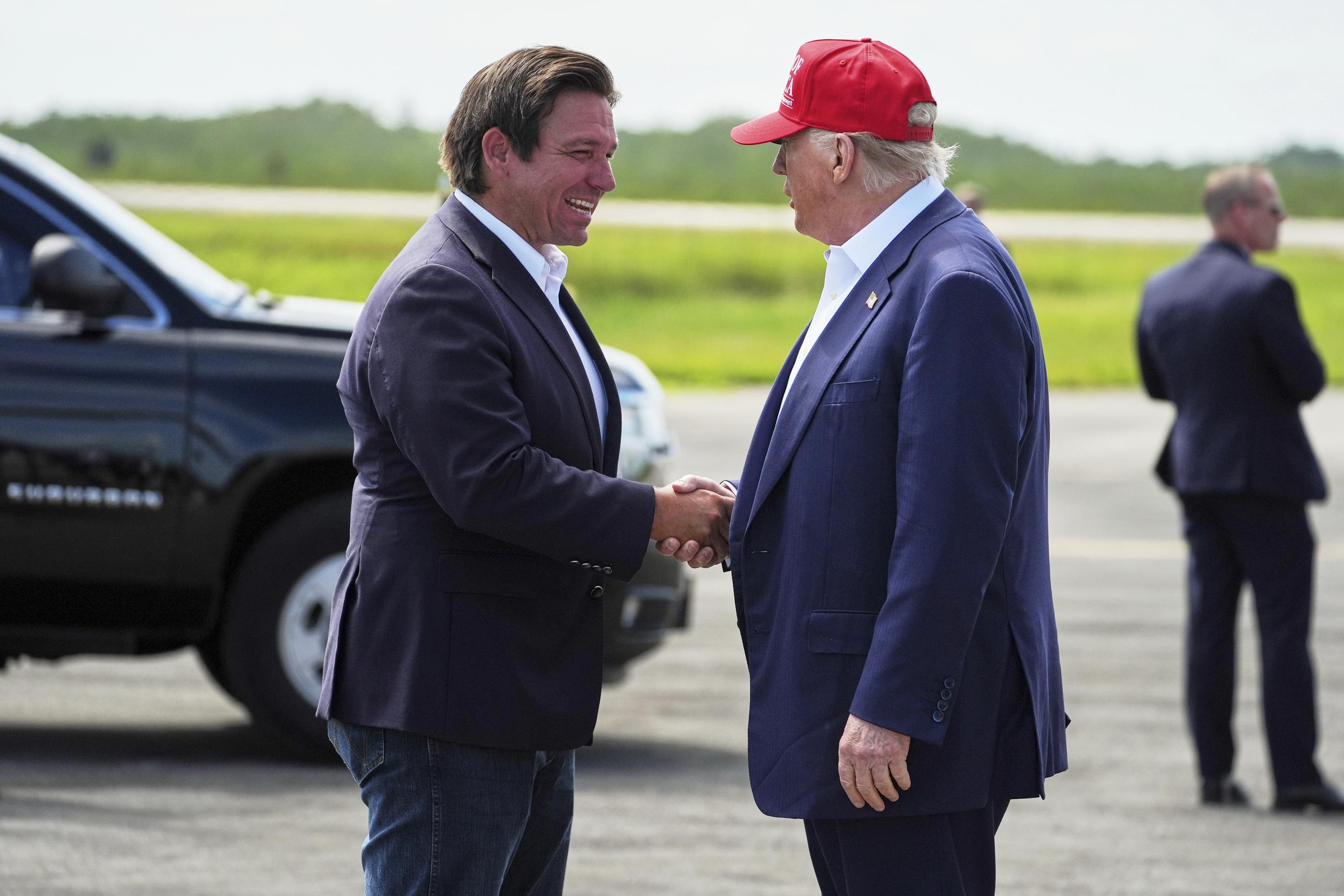 President Donald Trump is greeted by Gov. Ron DeSantis, R-Fla., as he arrives at "Alligator Alcatraz," a new migrant detention facility at Dade-Collier Training and Transition facility, Tuesday, July 1, 2025, in Ochopee, Fla. (AP Photo/Evan Vucci)