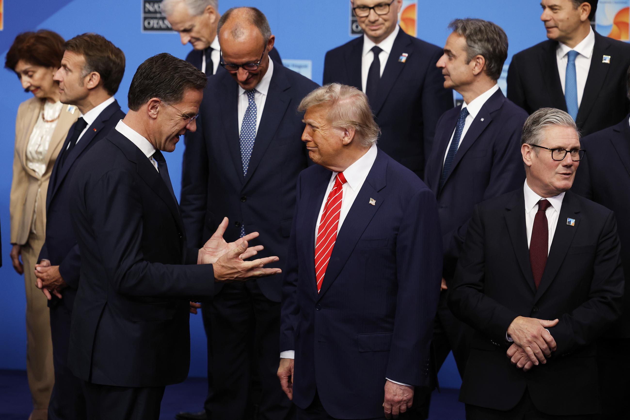 President Trump speaks with NATO Secretary General Mark Rutte during a group photo at the NATO summit in The Hague, Netherlands, on June 25. (AP Photo/Geert Vanden Wijngaert)