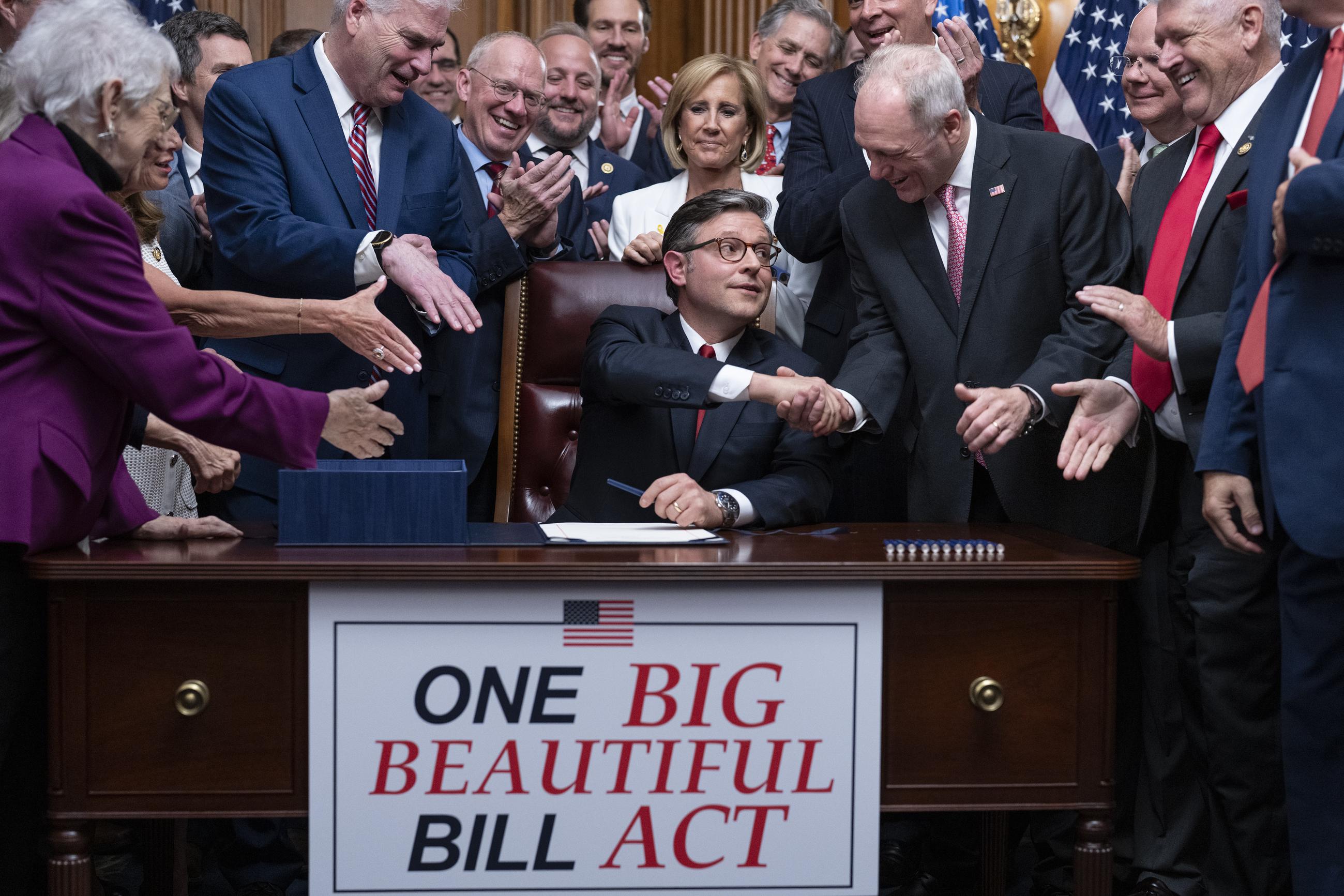 House Speaker Mike Johnson shakes hands with Majority Leader Steve Scalise as he celebrates with fellow Republicans after final passage of President Trump's signature bill of tax breaks and spending cuts at the Capitol on Thursday. (AP Photo/J. Scott Applewhite)