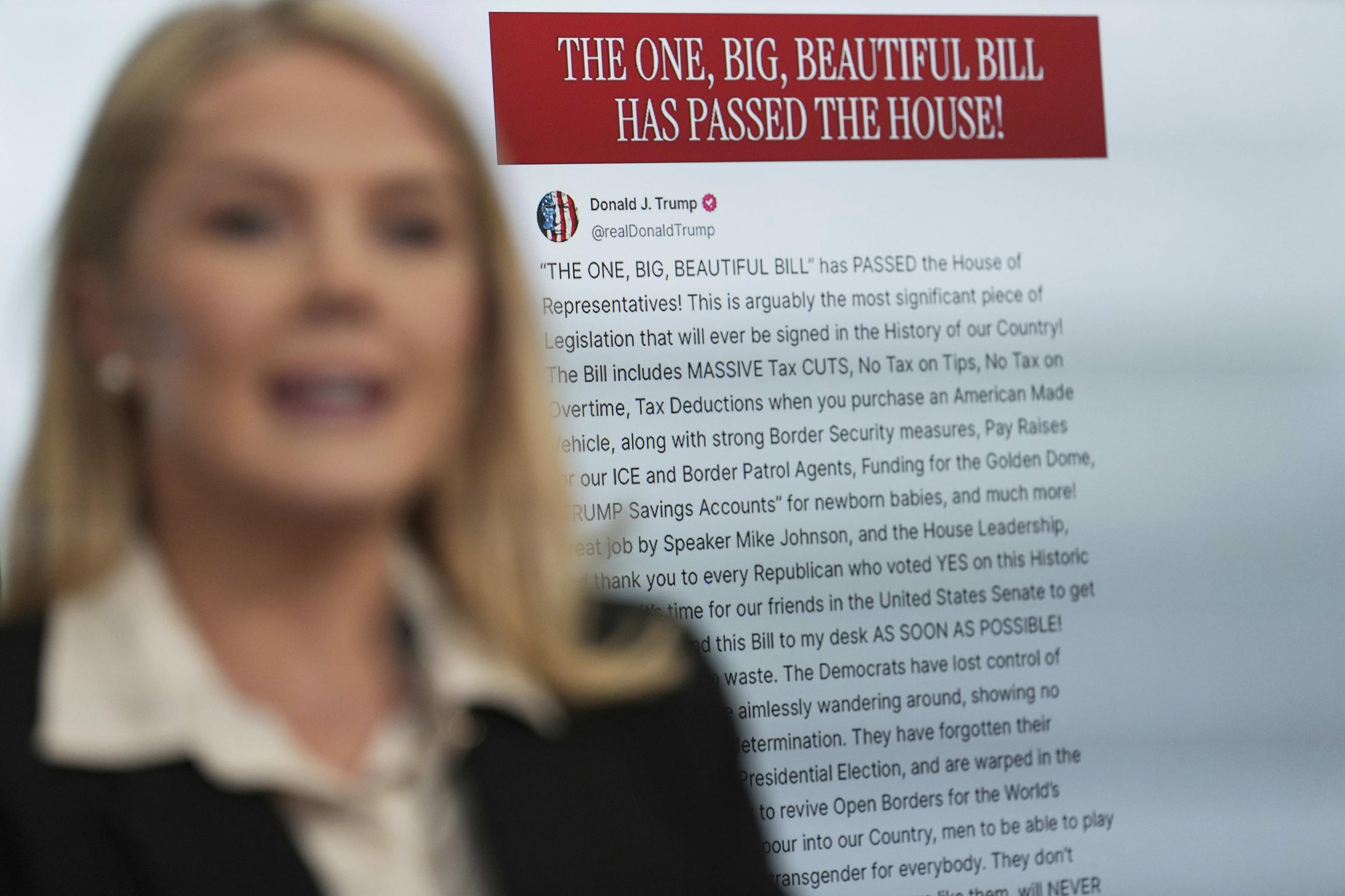 White House press secretary Karoline Leavitt speaks with reporters as an image of a Truth Social post by the president appears on screen in the briefing room on May 22. (AP Photo/Jacquelyn Martin)