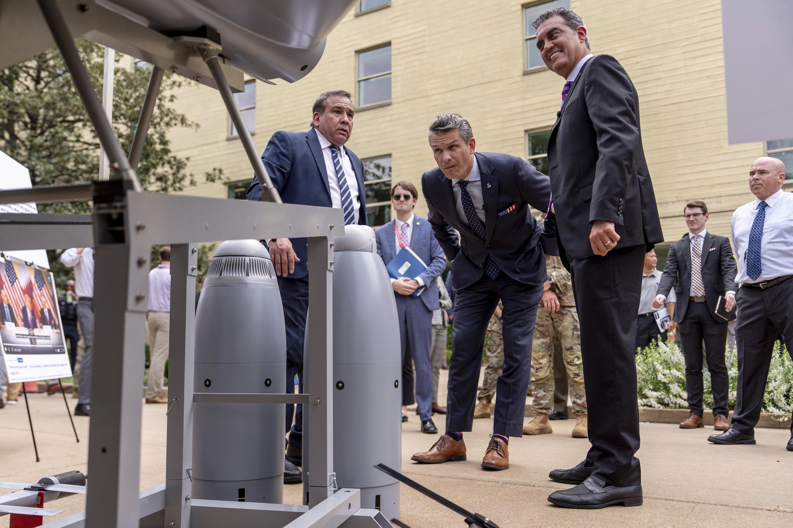 Defense Secretary Pete Hegseth and other officials at a display of multi-domain autonomous systems in the Pentagon courtyard on July 16. (AP Photo/Julia Demaree Nikhinson)
