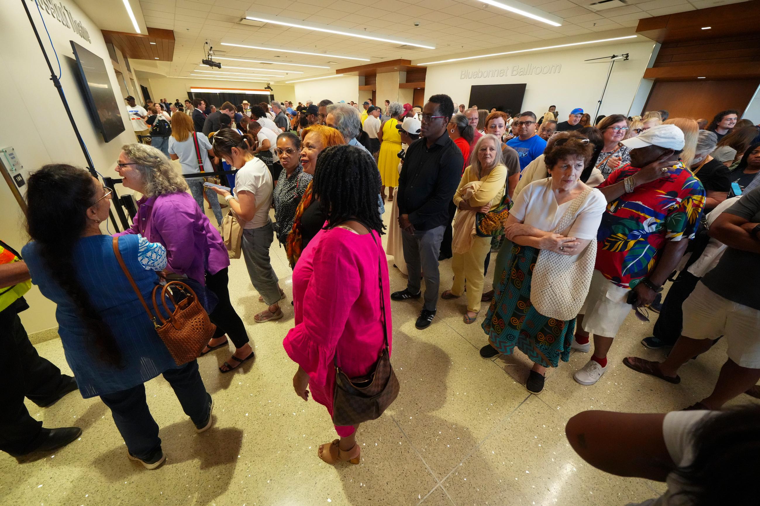 People gather while attempting to attend a redistricting hearing at the University of Texas Arlington campus Monday, July 28, 2025, in Arlington, Texas. (AP Photo/Julio Cortez)
