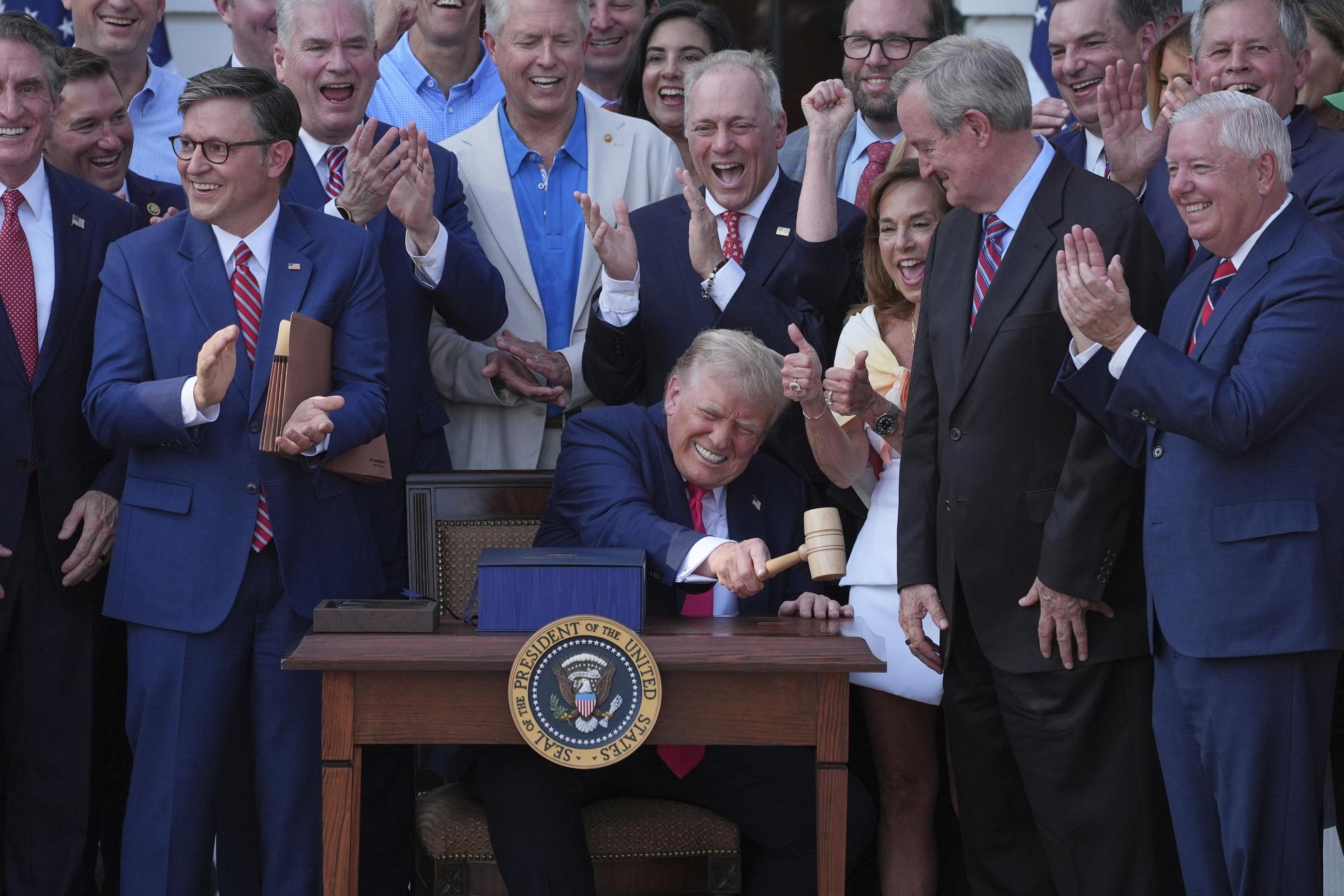 President Trump pounds a gavel presented to him by House Speaker Mike Johnson after he signed the One Big Beautiful Bill, July 4, 2025. (AP Photo/Evan Vucci)