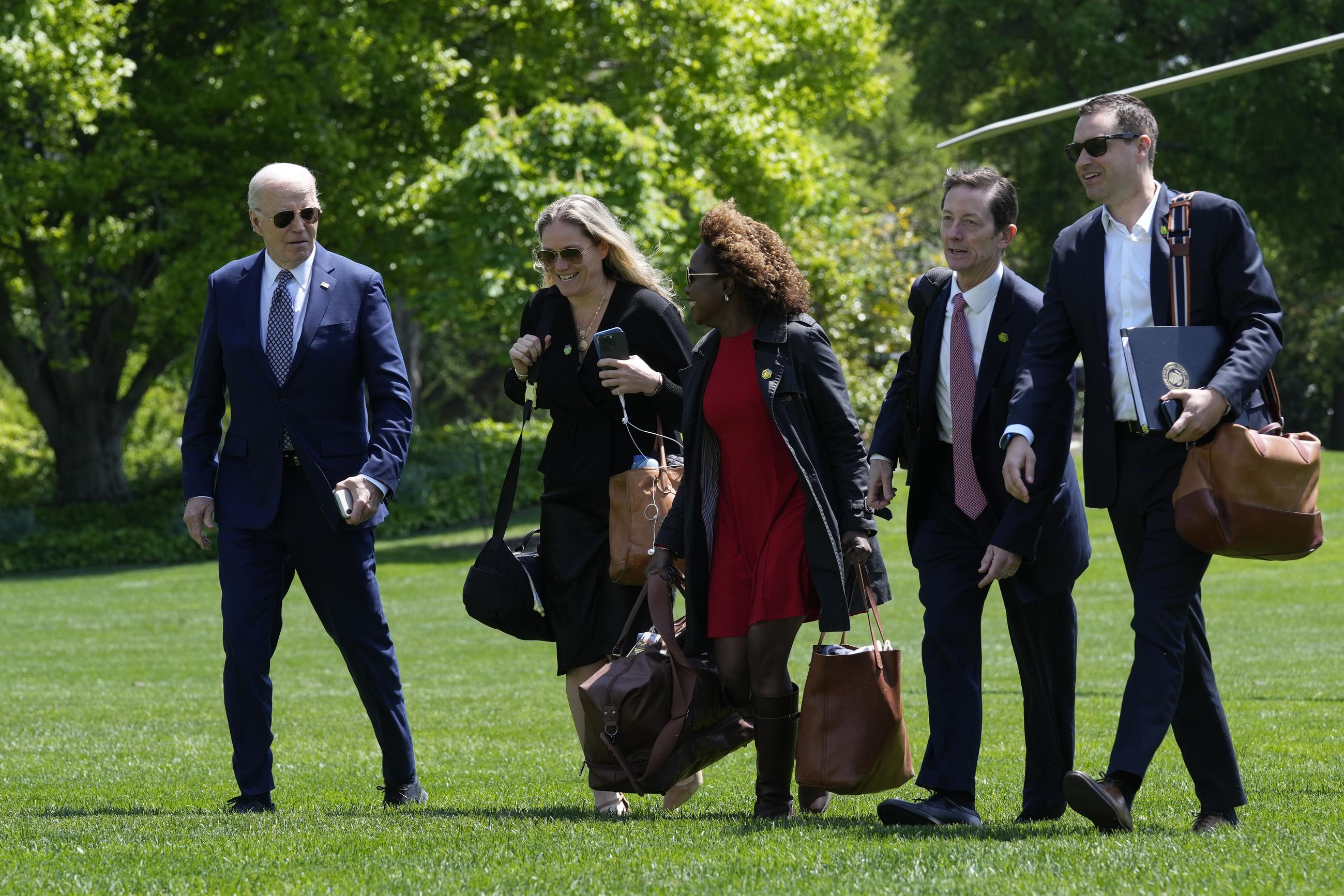 President Biden walks with White House deputy chief of staff Annie Tomasini, White House press secretary Karine Jean-Pierre, White House deputy chief of staff Bruce Reed, and White House communications director Ben LaBolt after returning from a trip to New York, April 26, 2024. (AP Photo/Susan Walsh)