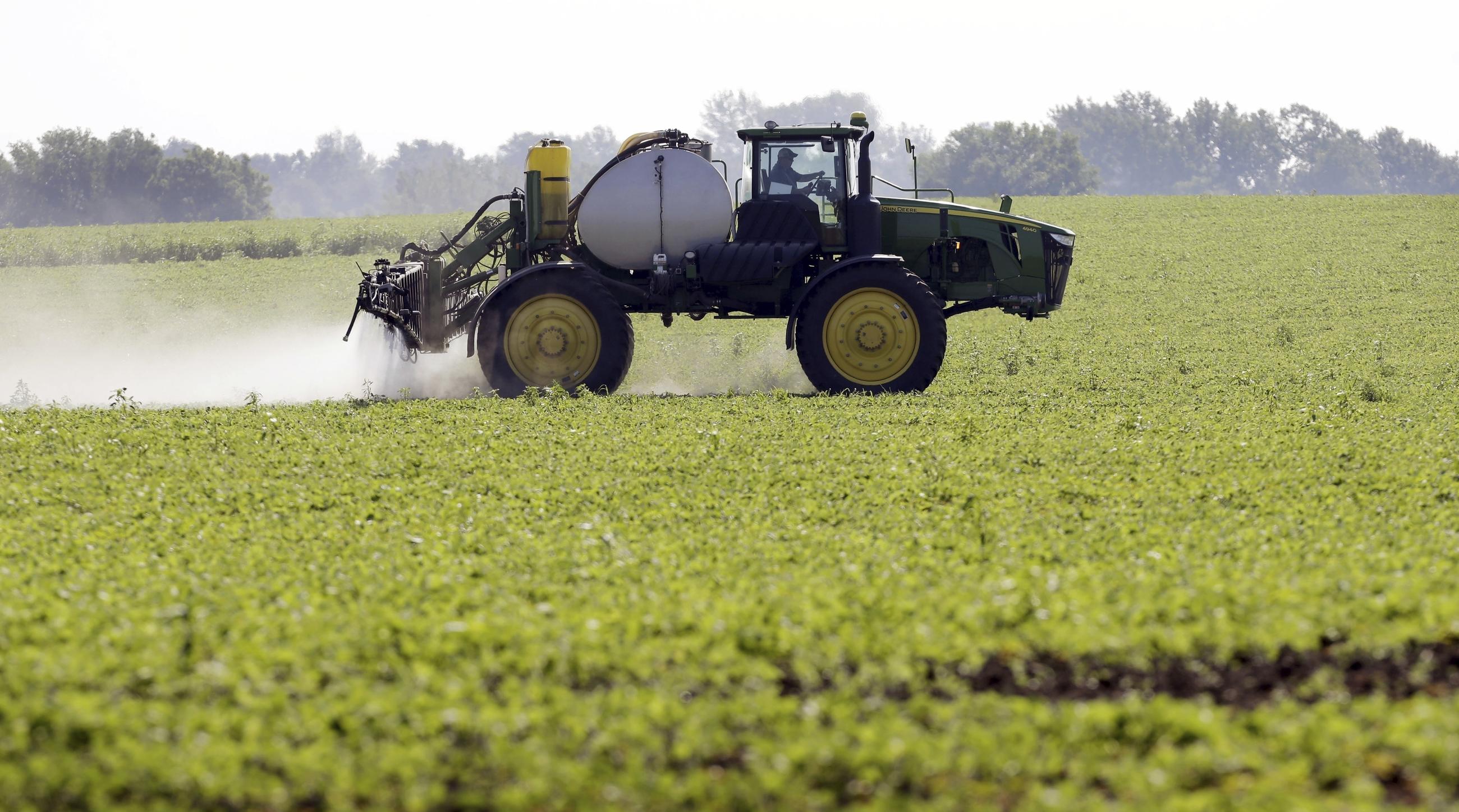 A farmer sprays a soybean field in Iowa in 2013. (AP Photo/Charlie Neibergall)