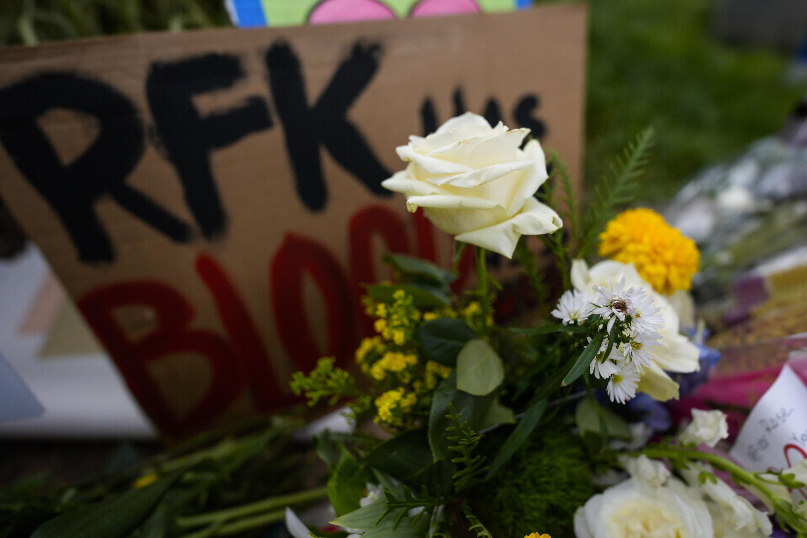 A memorial is seen in the aftermath of a shooting near the Centers for Disease Control and Prevention in Atlanta, where DeKalb County Police Officer David Rose was killed. (AP Photo/Mike Stewart)