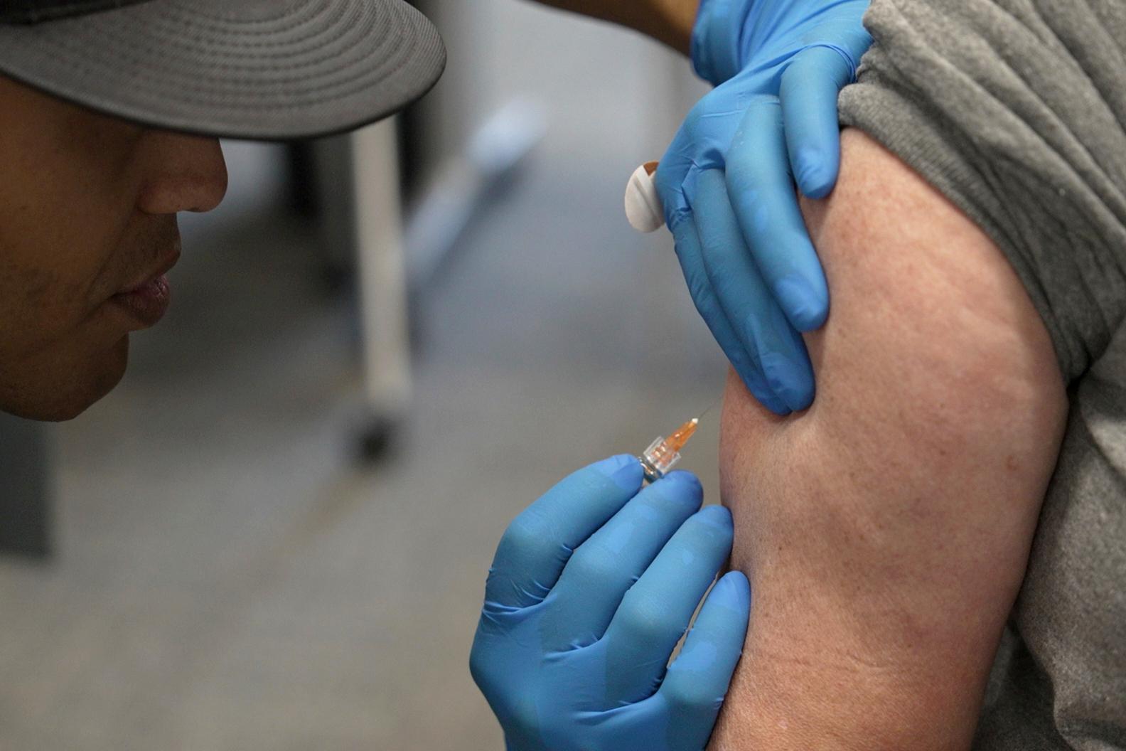 A Fire Department official administers an MMR vaccine in Lubbock, Texas. (AP Photo/Mary Conlon, File)