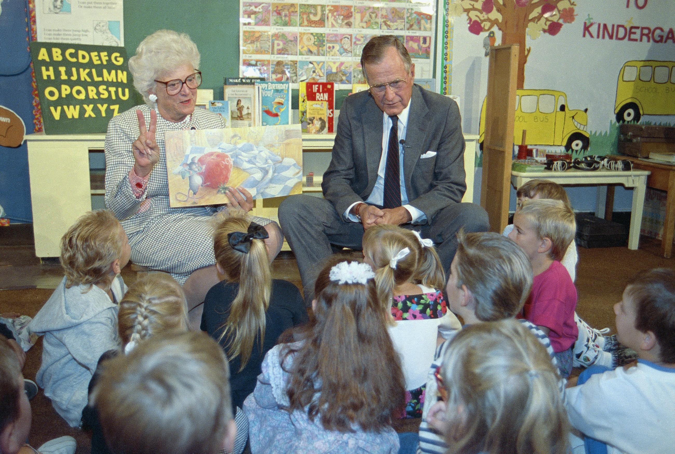 President George H.W. and Mrs. Bush read the book "The Hungry Bear" to a group of kindergarten students at Farwell Elementary school in Lewiston on Tuesday, Sept. 3, 1991. The president was in Lewiston to speak to an audience of students, parents and educators. (AP Photo/Greg Gibson)