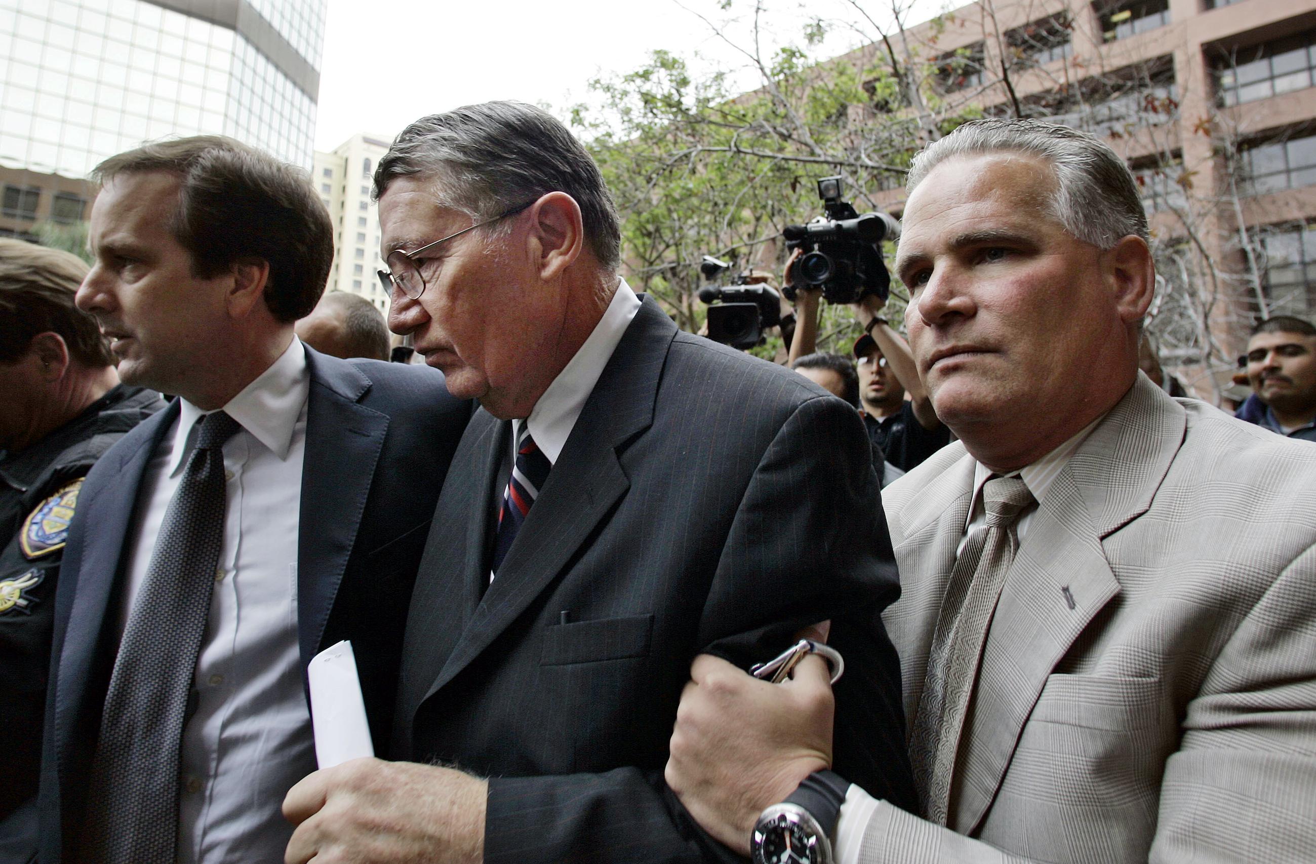 Former Rep. Randall "Duke" Cunningham (center) arrives at the federal courthouse in San Diego for sentencing on his conviction for bribery and tax evasion in March 2006. (AP Photo/Lenny Ignelzi)