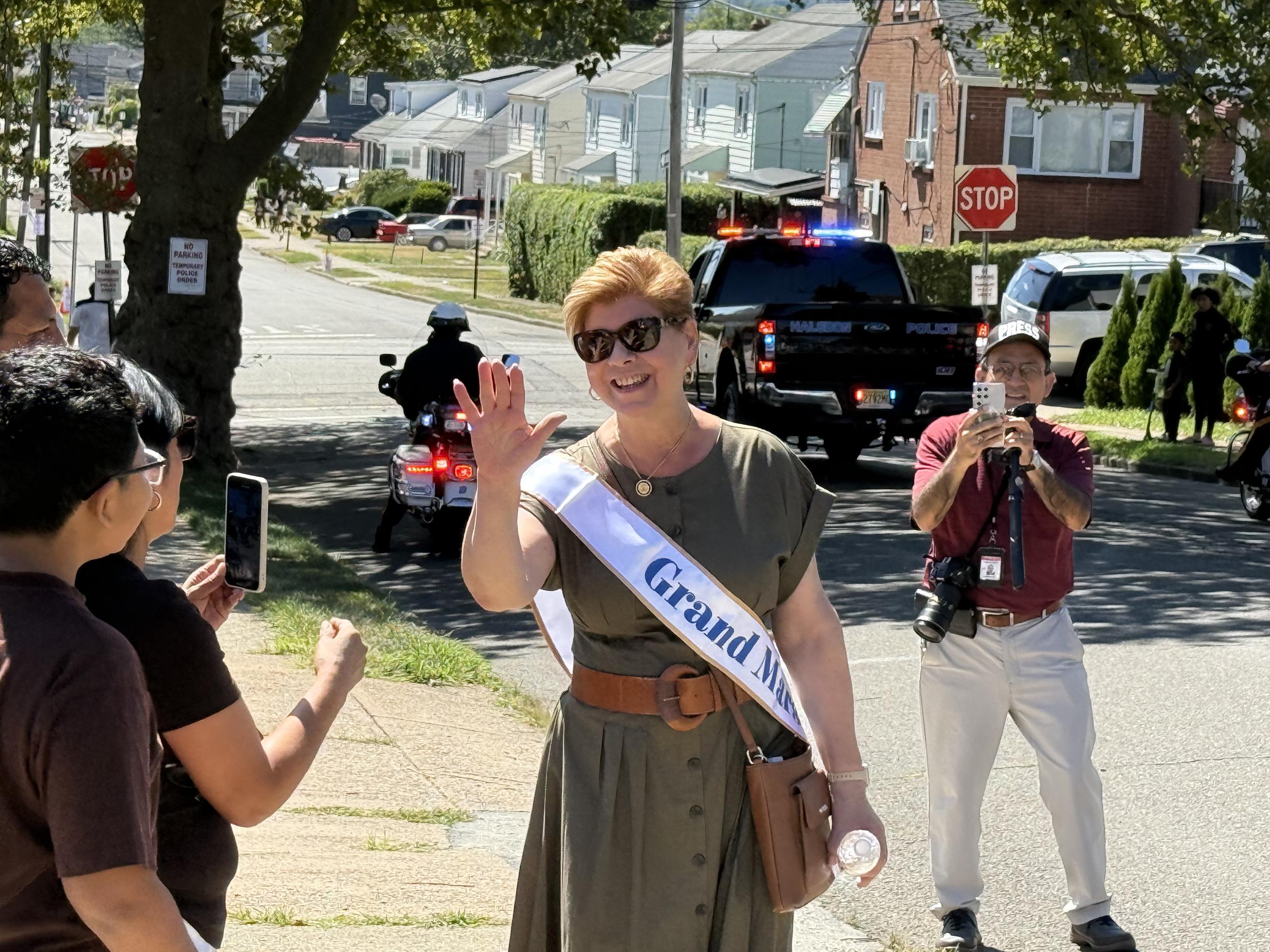 Rep. Nellie Pou greets onlookers at a Labor Day parade in Haledon, New Jersey, on Aug. 31, 2025. (National Journal/Nicholas Anastácio)