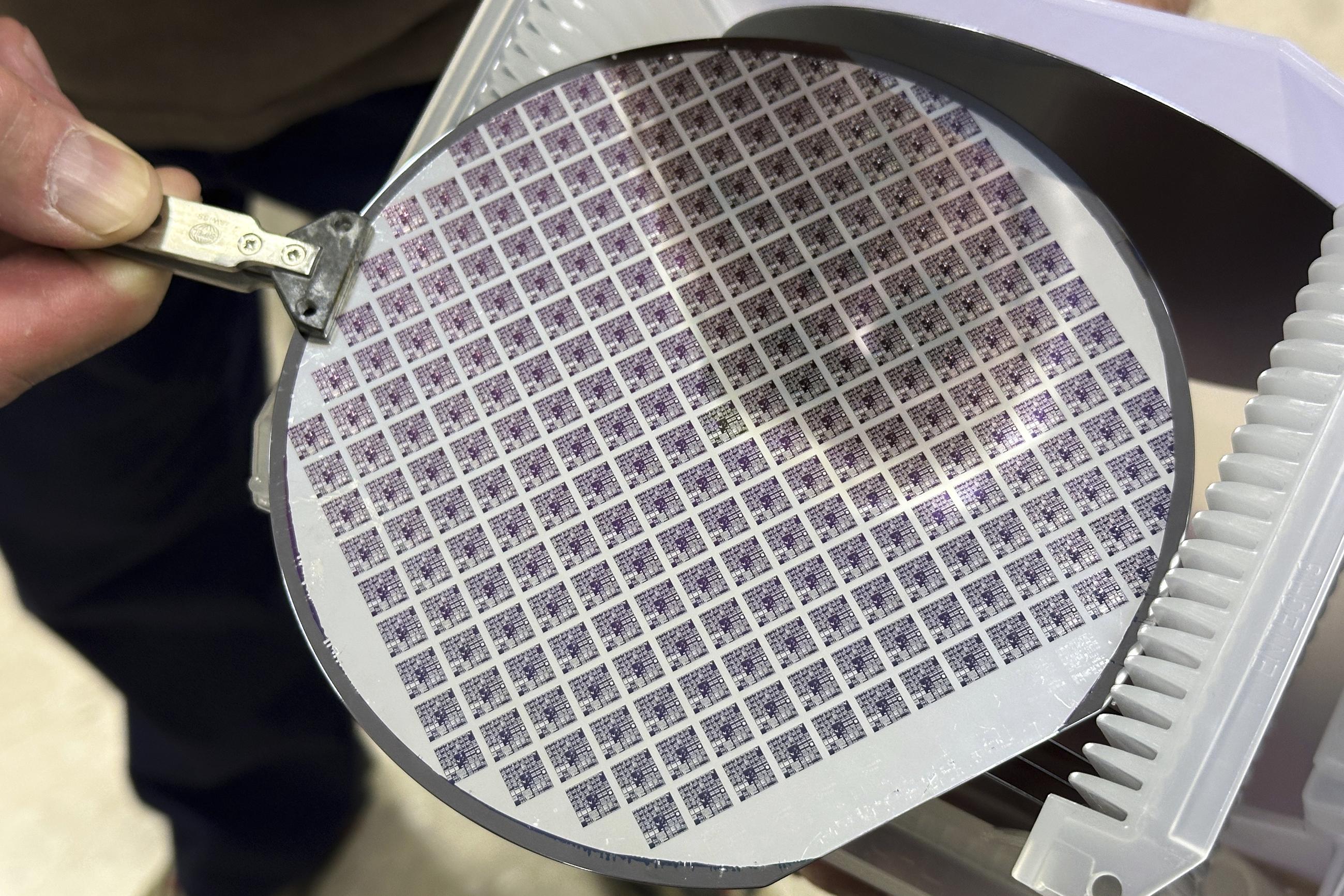 A semiconductor silicon wafer fabricated with several microchip microprocessors (AP Photo/Ted Shaffrey)