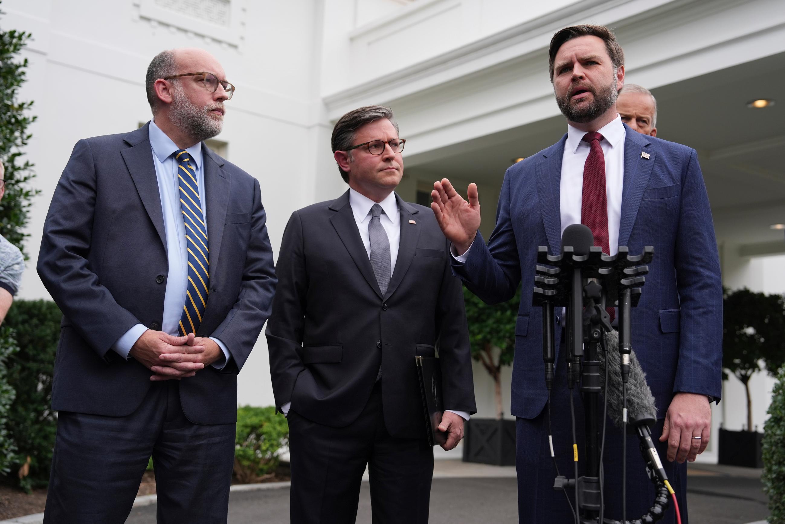Office of Management and Budget Director Russell Vought, House Speaker Mike Johnson, and Vice President J.D. Vance speak to the media outside the West Wing on Monday. (AP Photo/Evan Vucci)