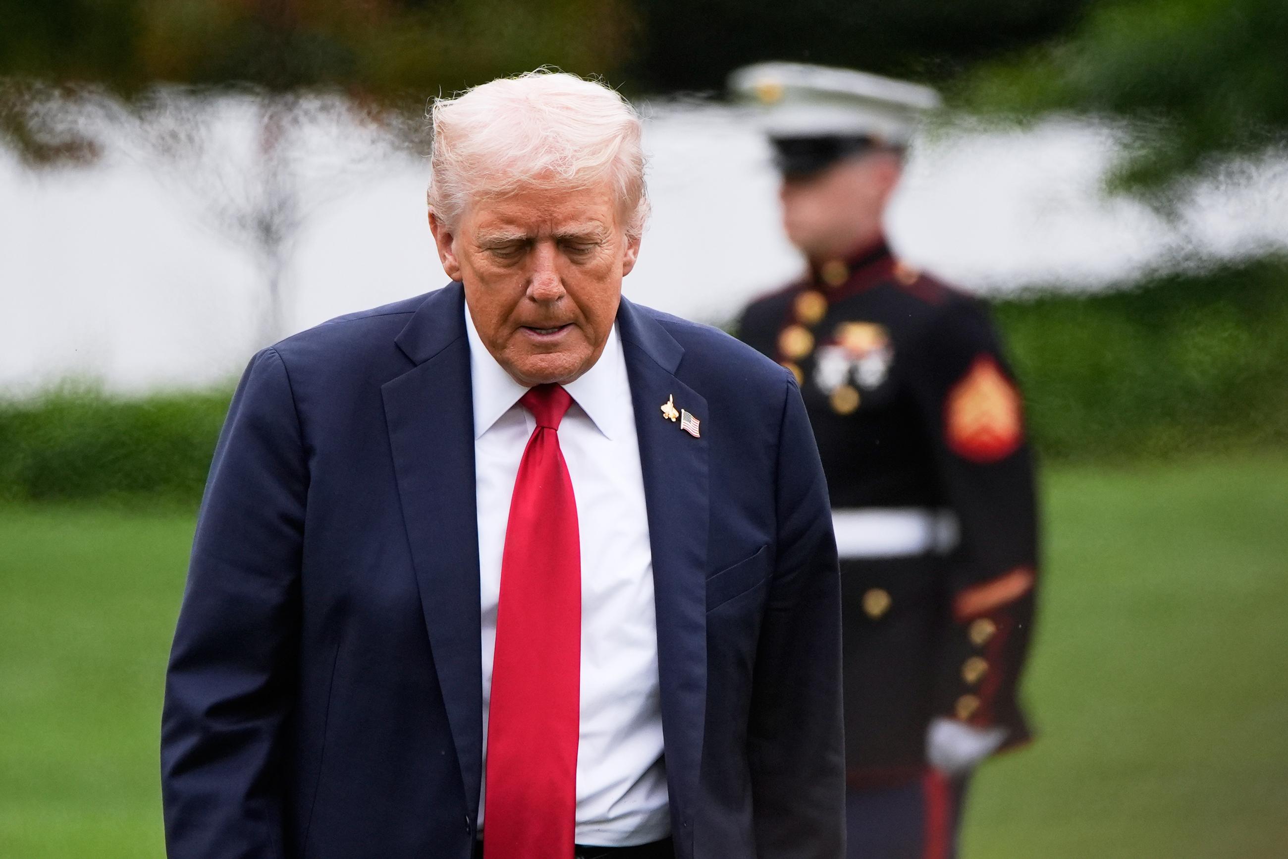 President Trump walks from Marine One after arriving on the South Lawn of the White House on Tuesday. (AP Photo/Alex Brandon)