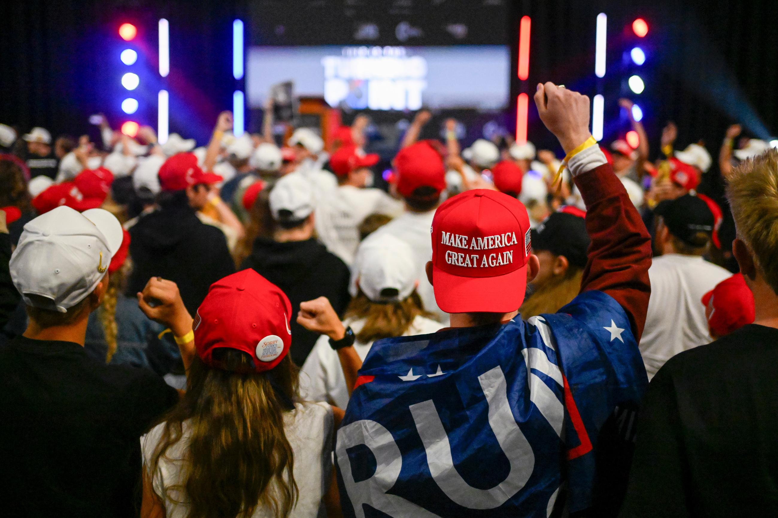 People cheer at a Turning Point USA rally on the campus of Utah State University, as a part of the organization's push to memorialize Charlie Kirk, Tuesday, Sept. 30, 2025, in Logan, Utah. (AP Photo/Alex Goodlett)