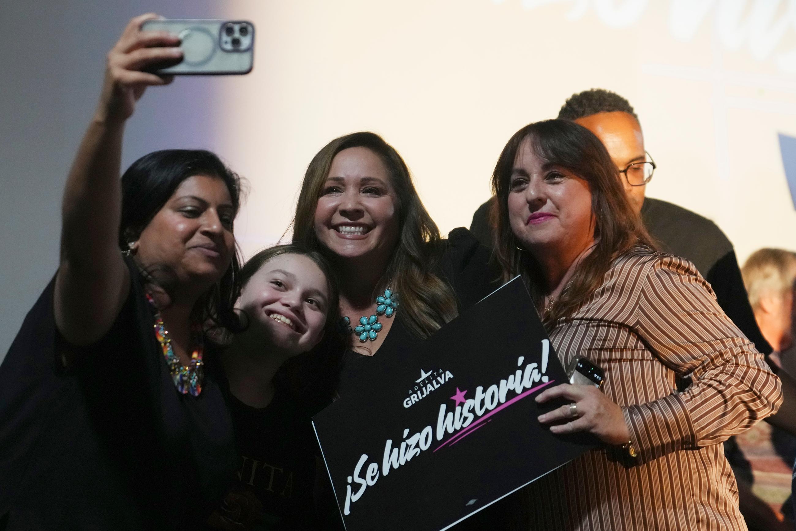 Arizona Democratic candidate Adelita Grijalva, center, poses for a selfie with supporters after being declared the winner against Republican Daniel Butierez to fill the Congressional District 7 seat held by the late U.S. Rep. Raúl Grijalva in a special election Tuesday, Sept. 23, 2025, in Tucson, Ariz. (AP Photo/Ross D. Franklin)