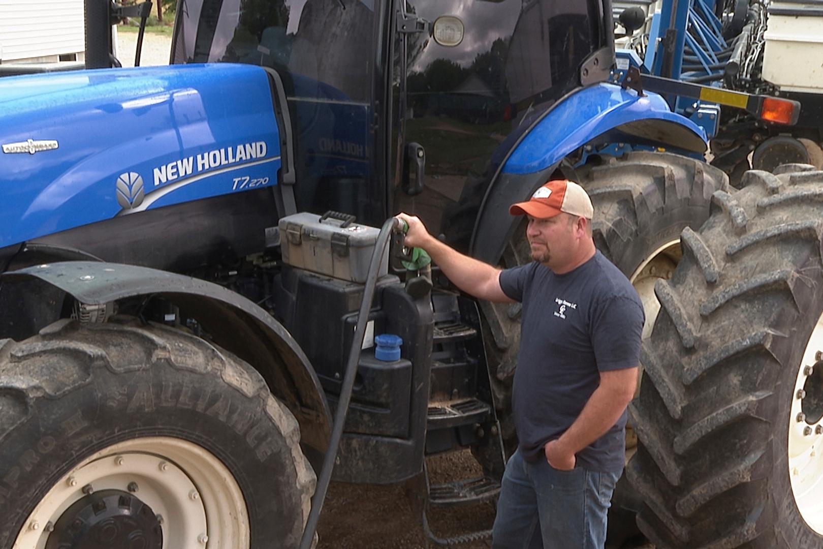 In this image from video in May, Matt Griggs fills up his tractor with fuel at his farm in Humboldt, Tenn. Griggs, like many American farmers, is paying close attention to the trade war between the U.S. and China, a critical market for soybeans. (AP photo/Kristin M. Hall)