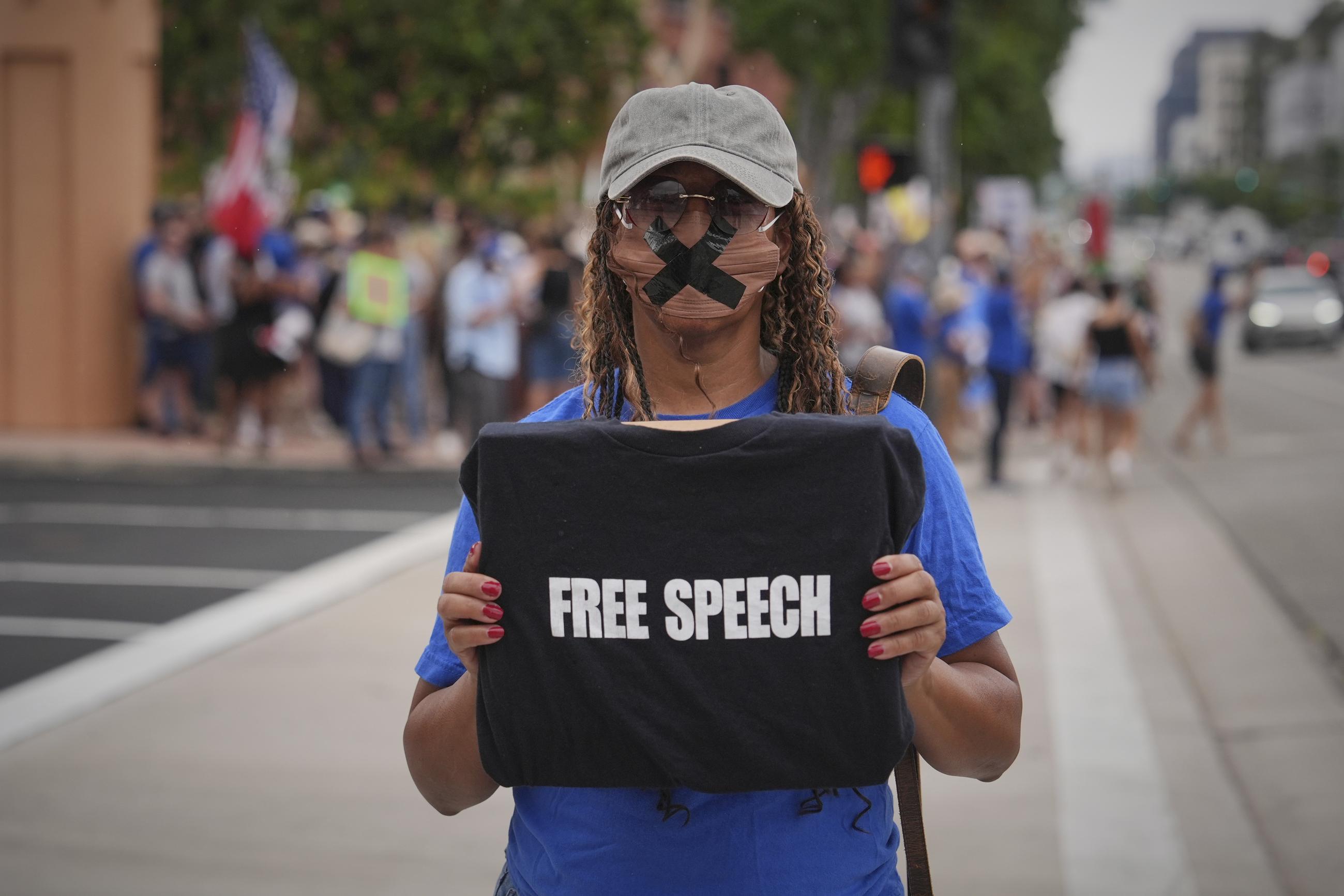 A demonstrator stands outside of The Walt Disney Studios in Burbank, Calif., in September protesting the suspension of Jimmy Kimmel's late-night show. (AP Photo/Jae C. Hong)