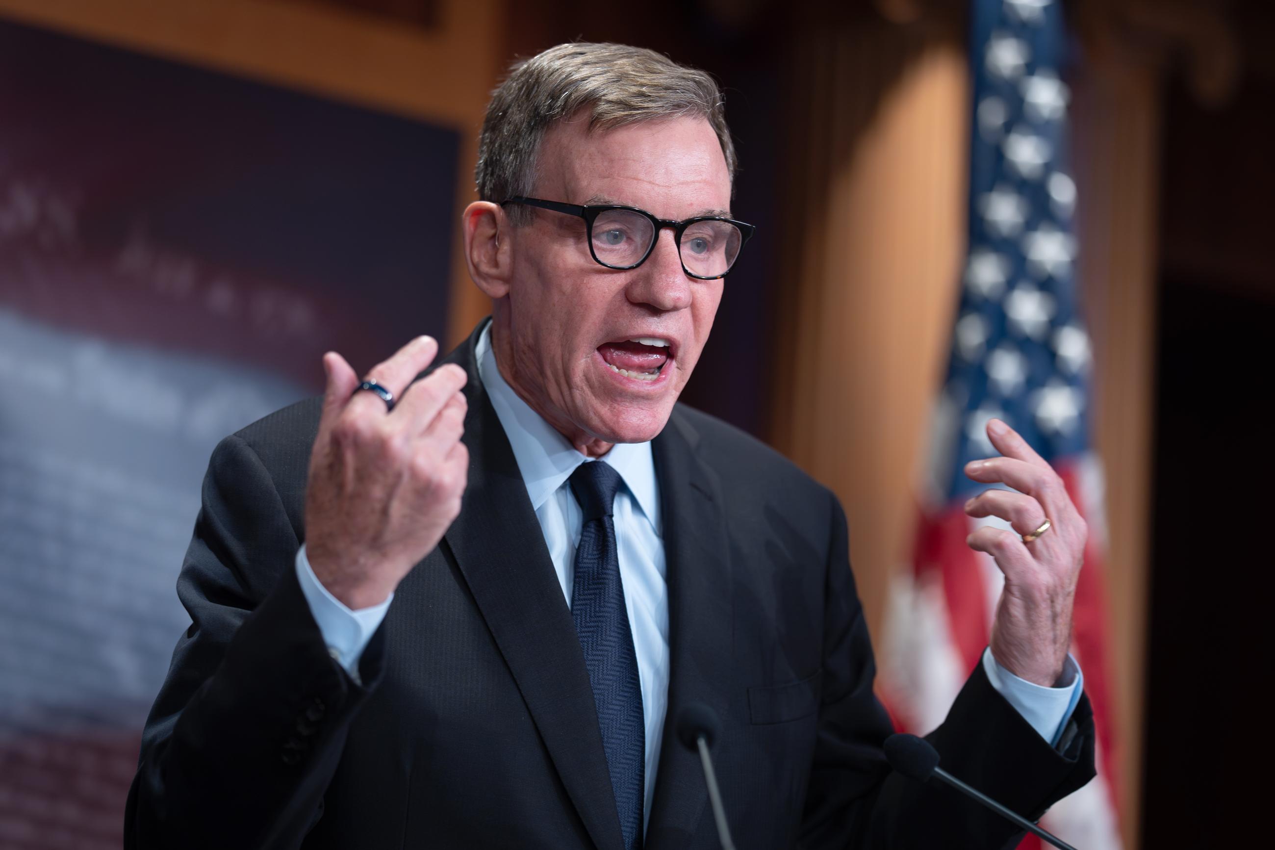 Sen. Mark Warner criticizes the Trump administration at a news conference Thursday following reports that only Republican lawmakers received security briefings on the Trump-ordered military strikes against boats in the Caribbean. (AP Photo/J. Scott Applewhite)