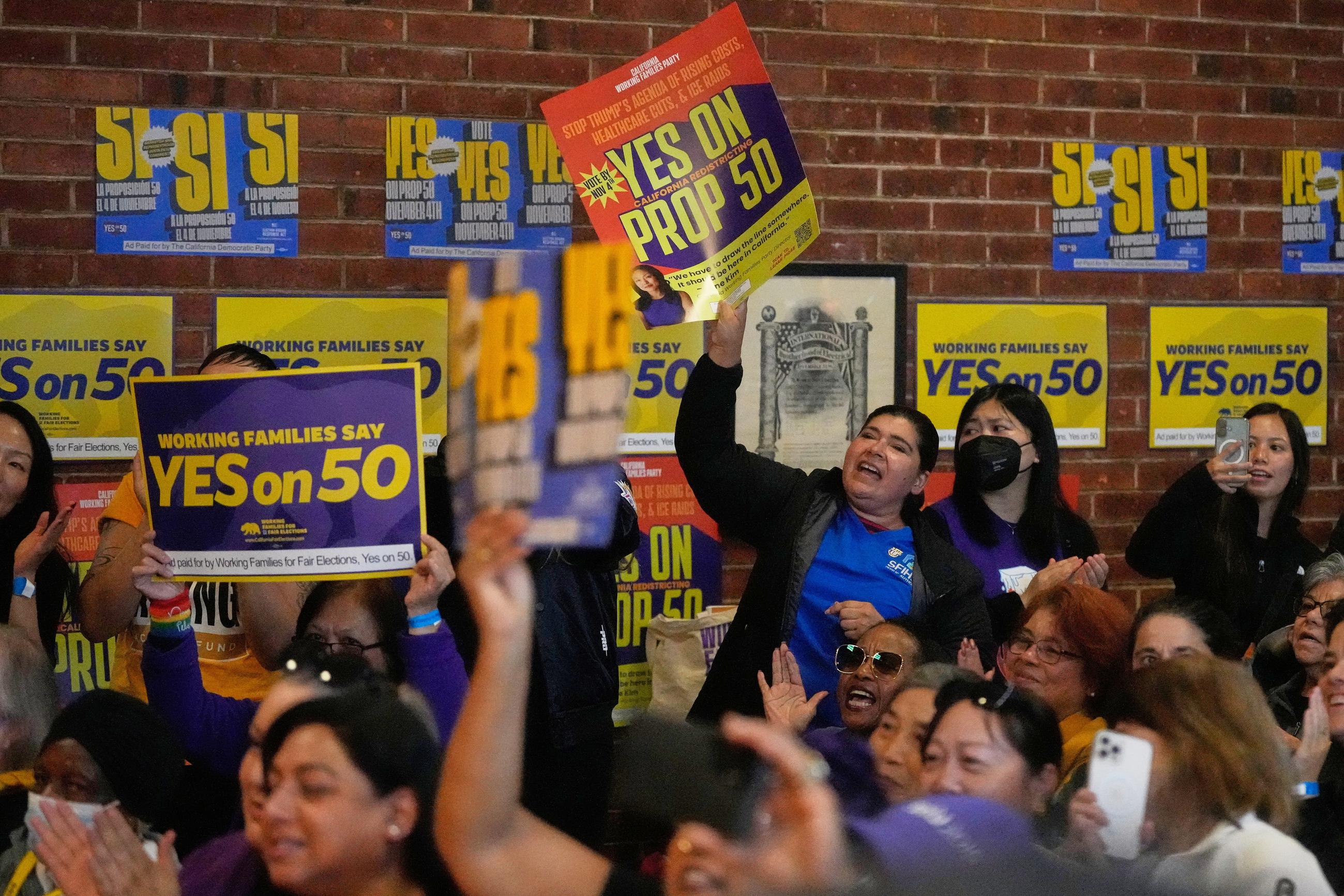 People cheer speakers during a campaign event on Proposition 50 in San Francisco Monday. (AP Photo/Jeff Chiu)