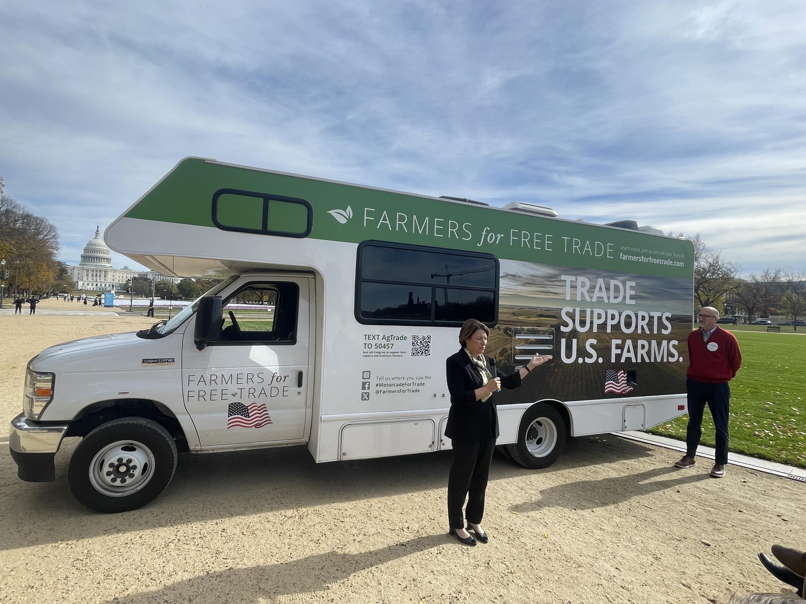 Sen. Amy Klobuchar of Minnesota speaks to Farmers for Free Trade. Brian Kuehl, executive director of the group, stands nearby. (Jerry Hagstrom/National Journal)