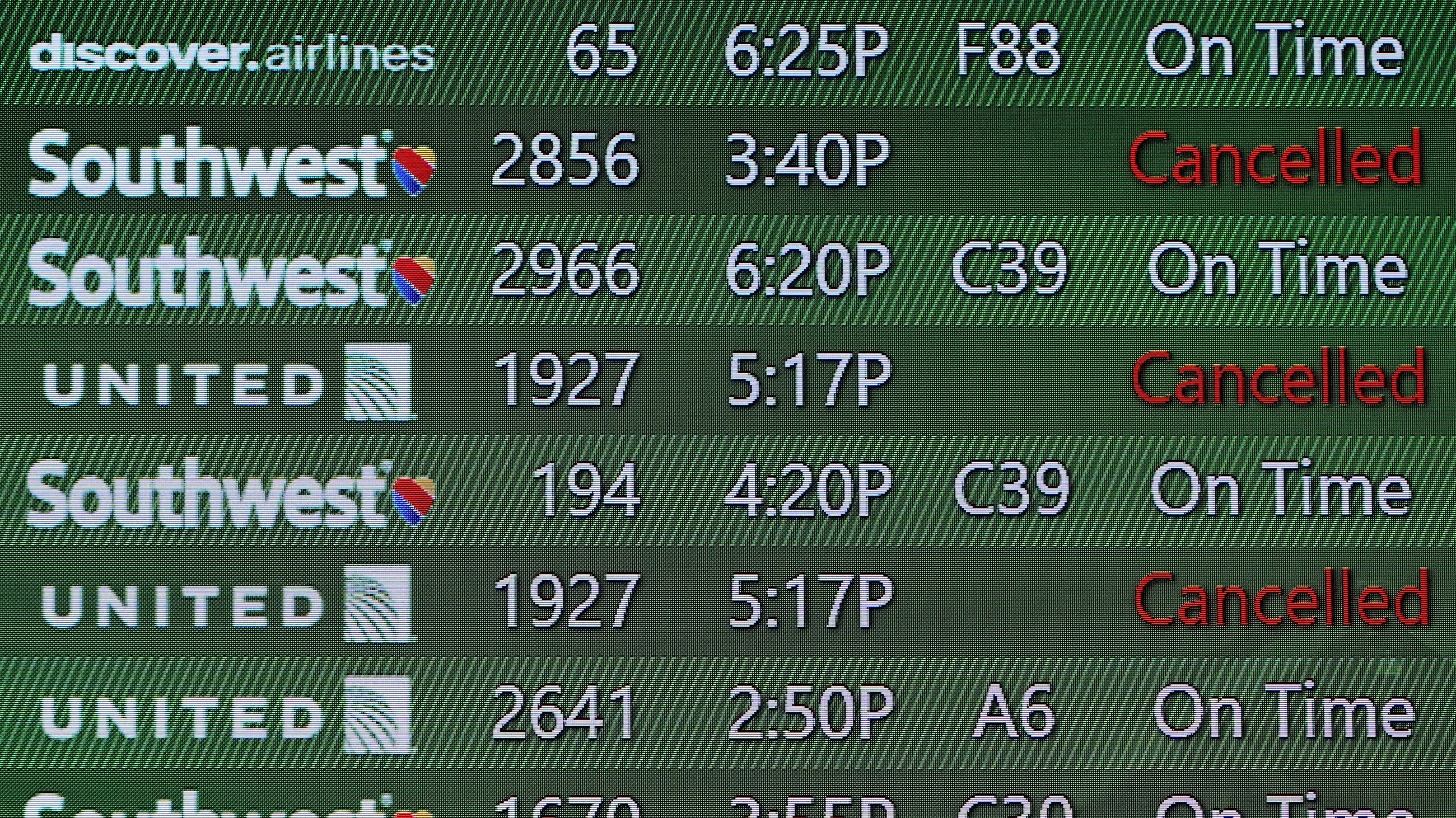 Cancelled flights into Tampa International Airport as shown on the arrivals board Tuesday (AP Photo/Chris O'Meara)