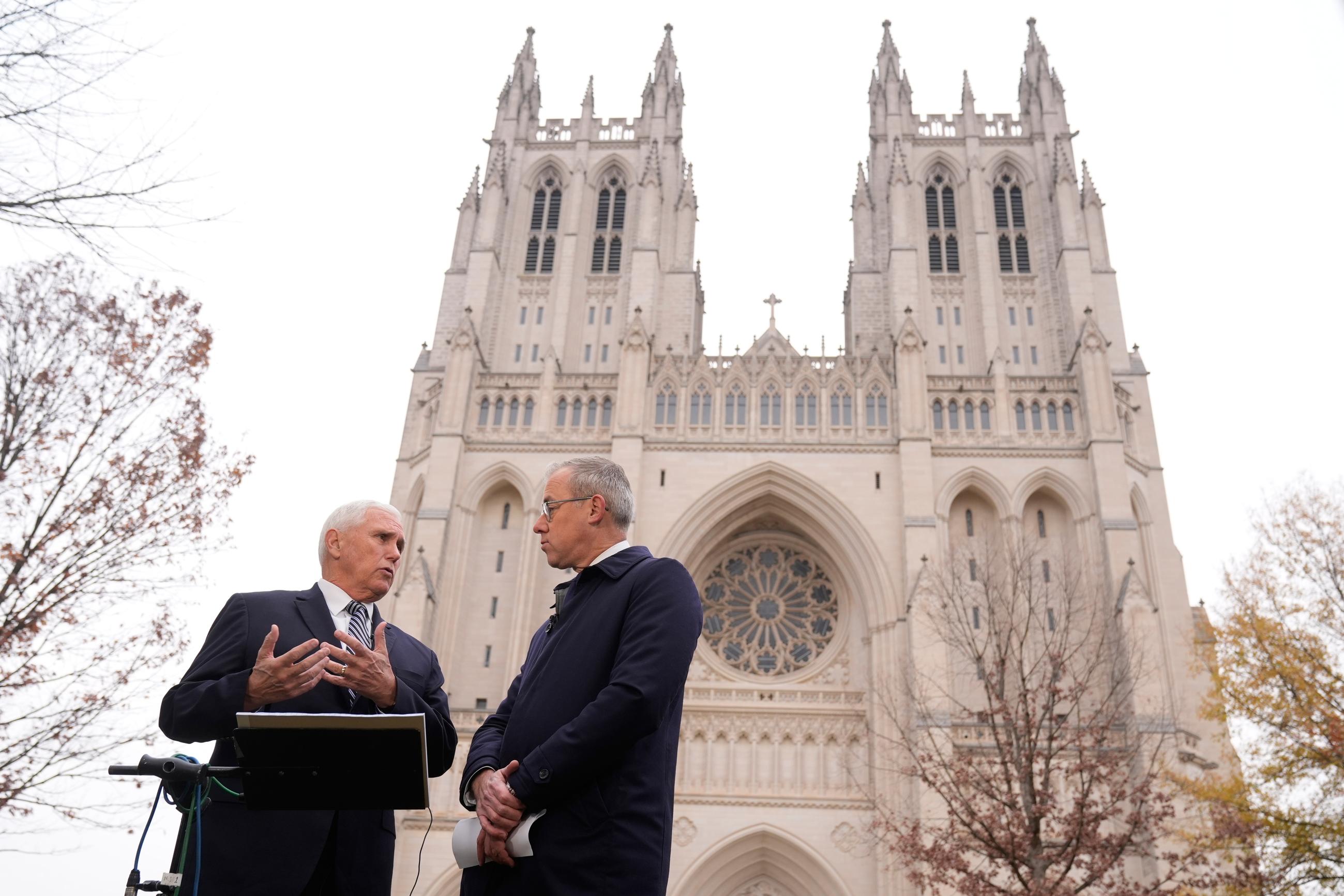 Former Vice President Mike Pence speaks to CNN journalist Jeff Zeleny before the funeral services. (AP Photo/Mark Schiefelbein)