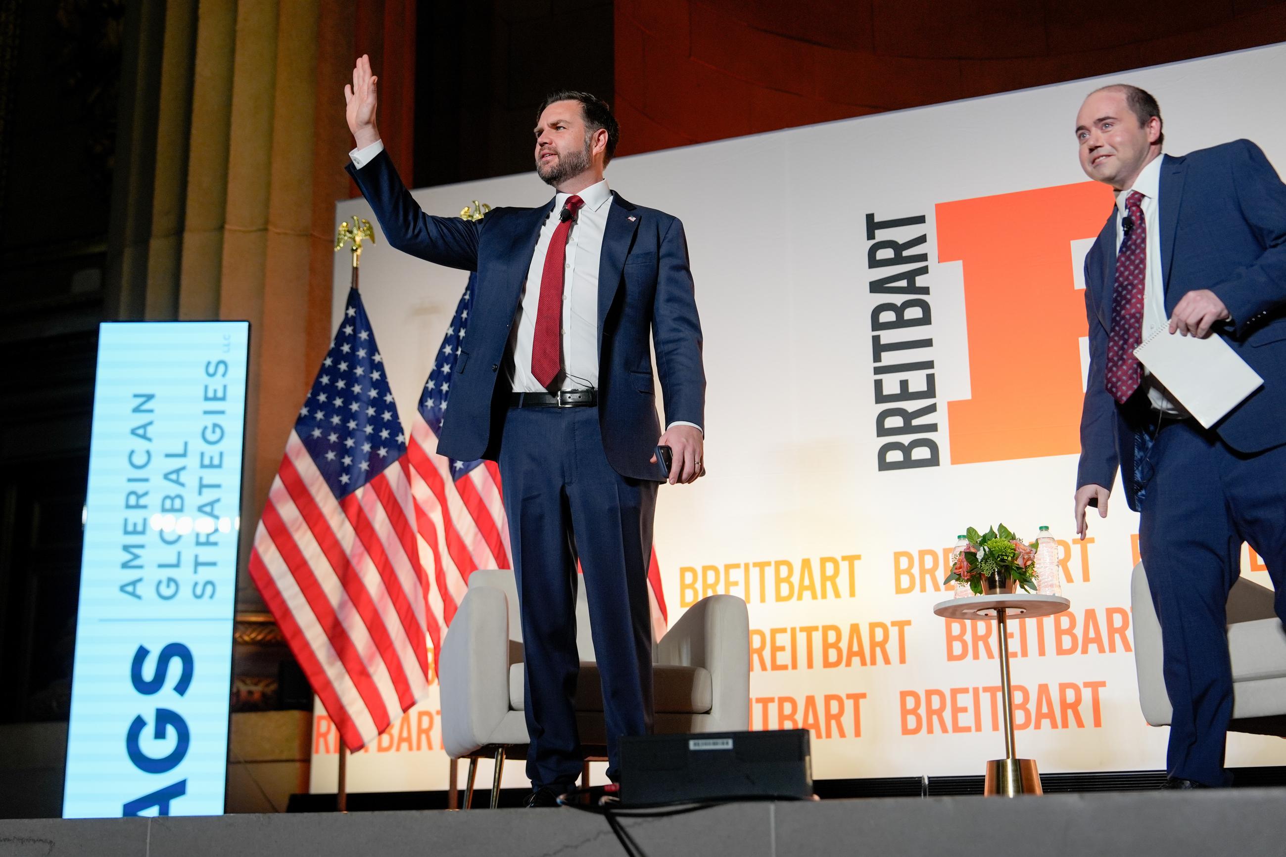Vice President JD Vance, left, arrives to speak with Breitbart News Washington bureau chief Matthew Boyle, right, at Andrew W. Mellon Auditorium, Thursday, Nov. 20, 2025, in Washington. (AP Photo/Julia Demaree Nikhinson)