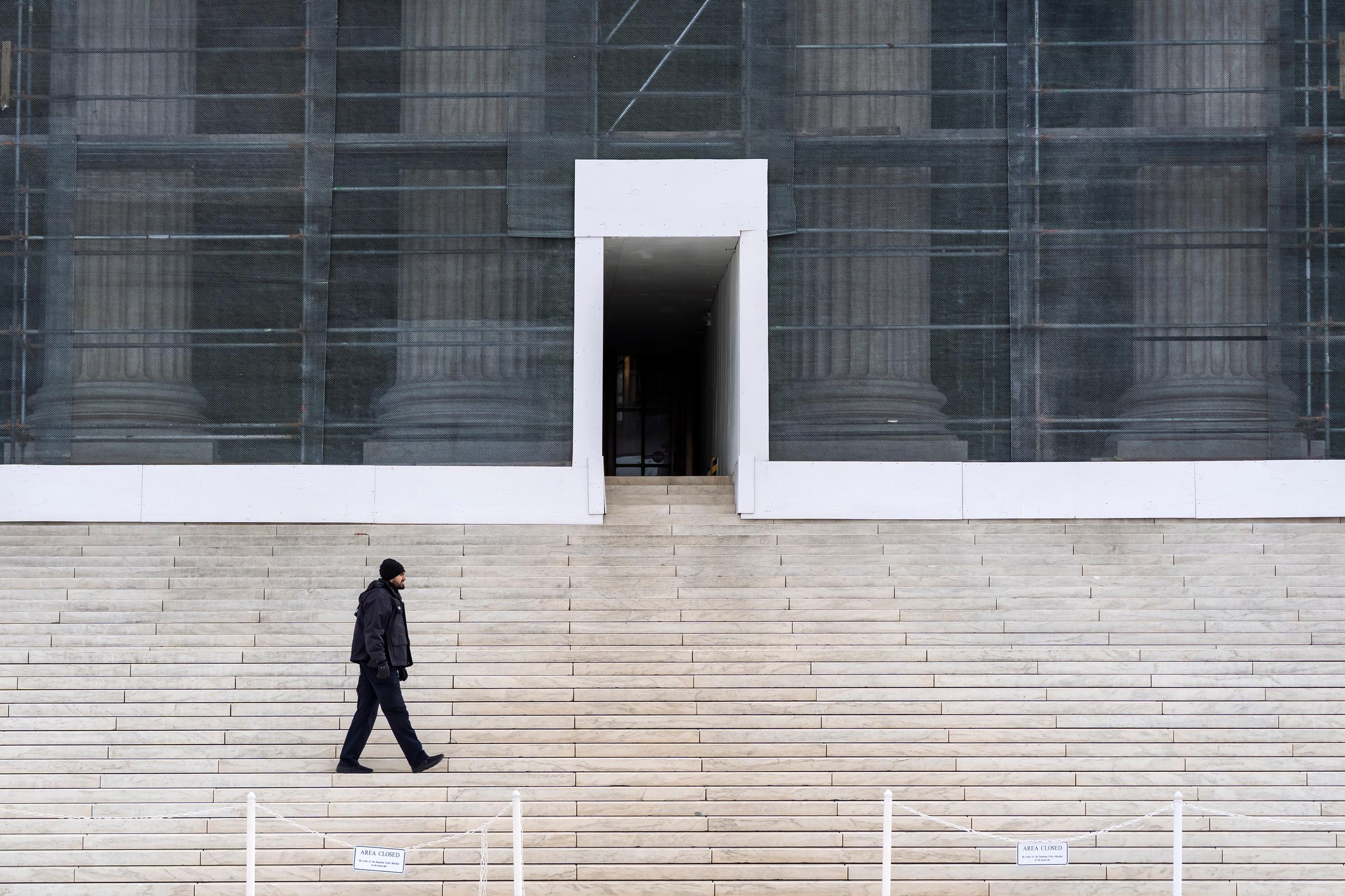 A U.S. Supreme Court police officer walks in front of the Court amid renovations on Monday. (AP Photo/J. Scott Applewhite)