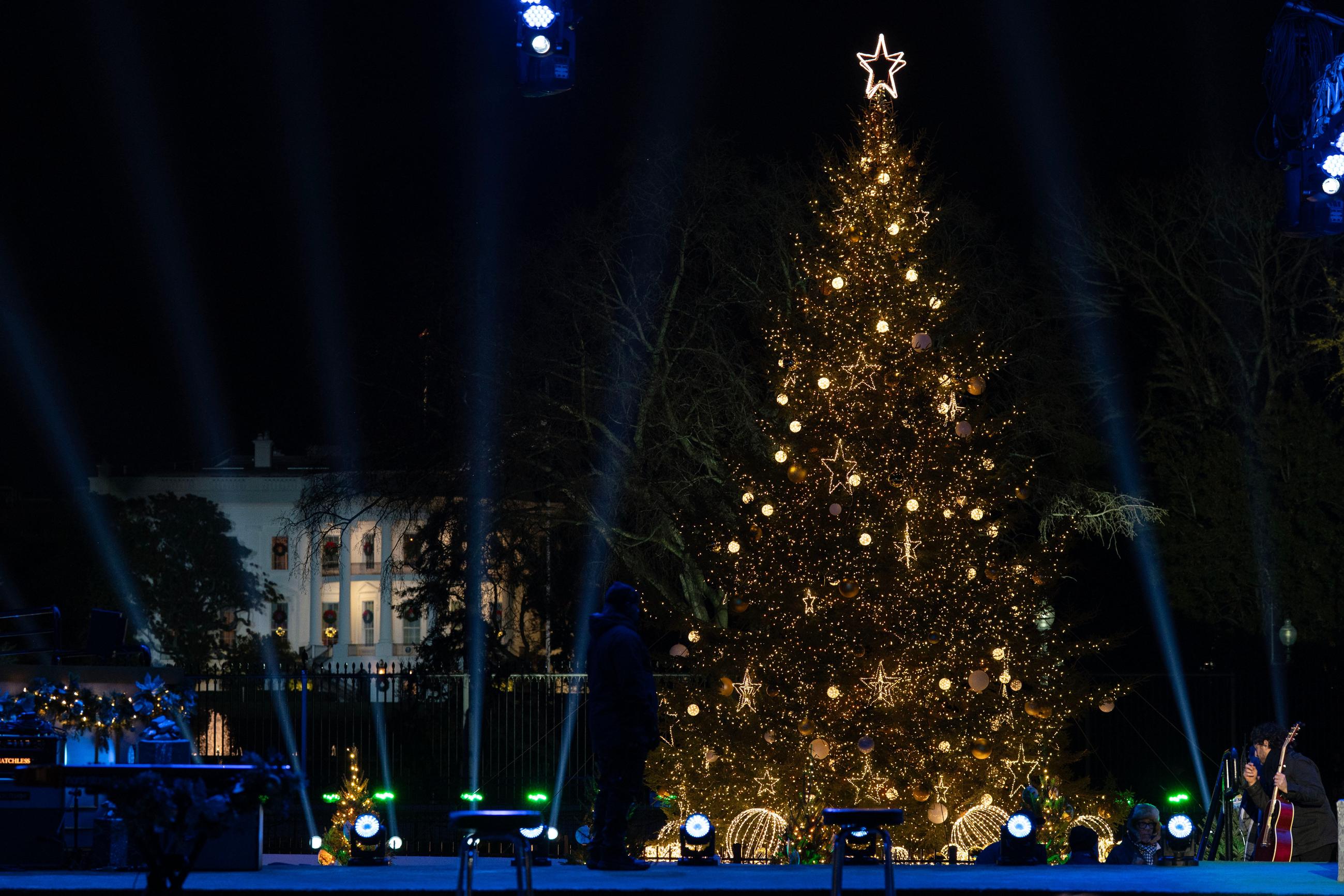 With the White House in the background, The National Christmas Tree is lit on the Ellipse, Thursday, Dec. 4, 2025 in Washington. (AP Photo/Jose Luis Magana)