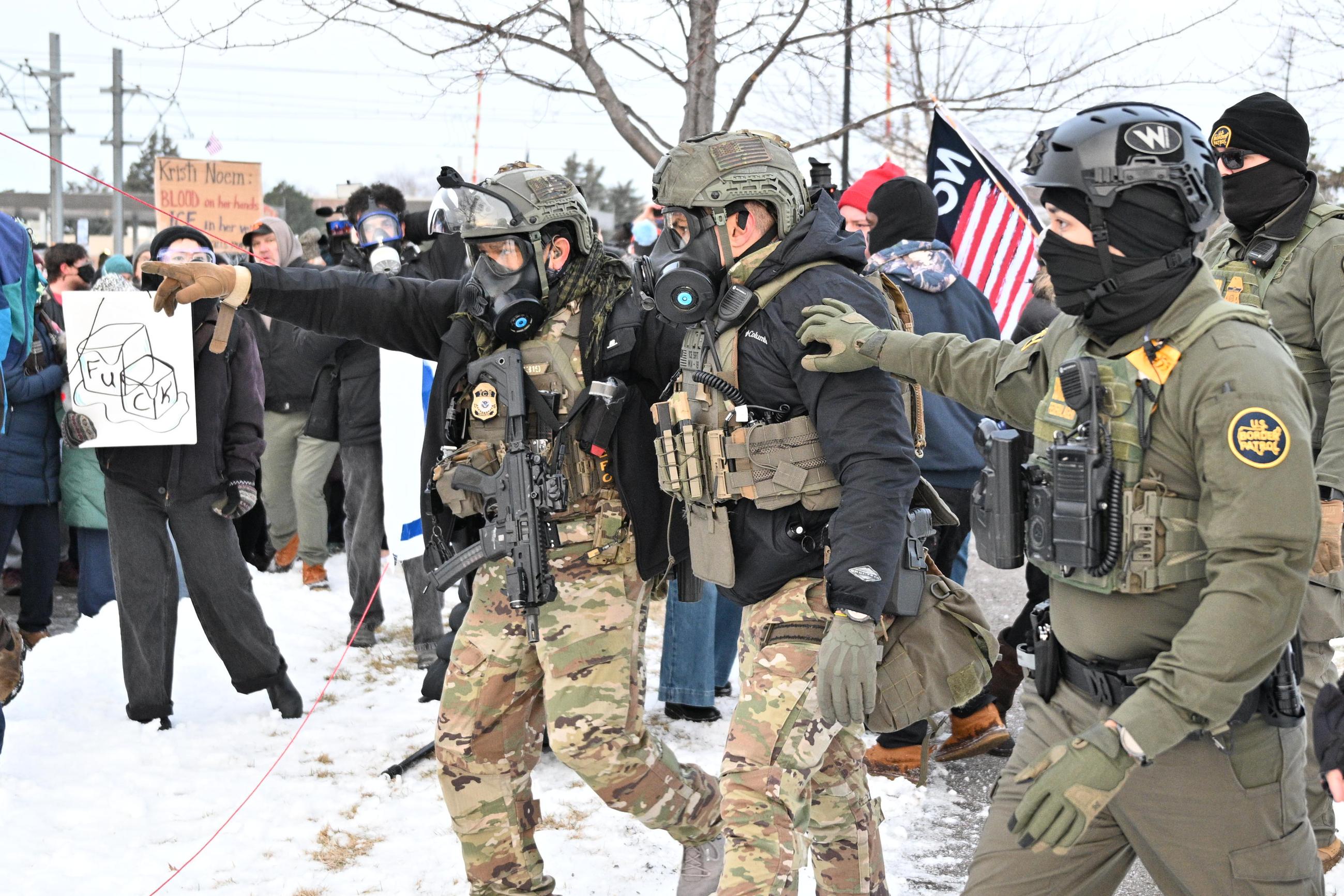EDS NOTE: OBSCENITY - Federal agents confront protesters outside the Bishop Henry Whipple Federal Building, Thursday, Jan. 8, 2026, in Minneapolis, Minn. (AP Photo/Tom Baker)