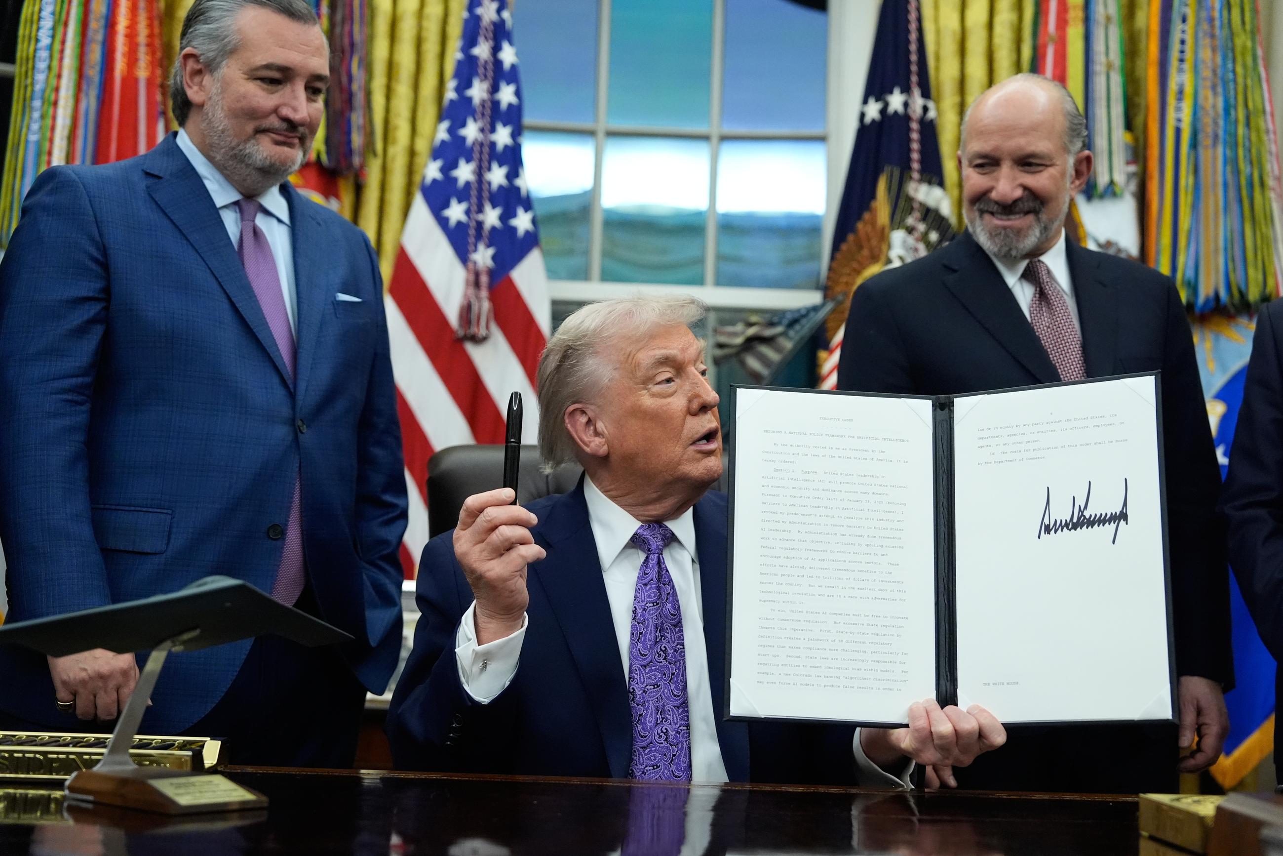 Flanked by Sen. Ted Cruz and Commerce Secretary Howard Lutnick, President Trump displays his signed AI initiative in the Oval Office on Dec. 11. (AP Photo/Alex Brandon)