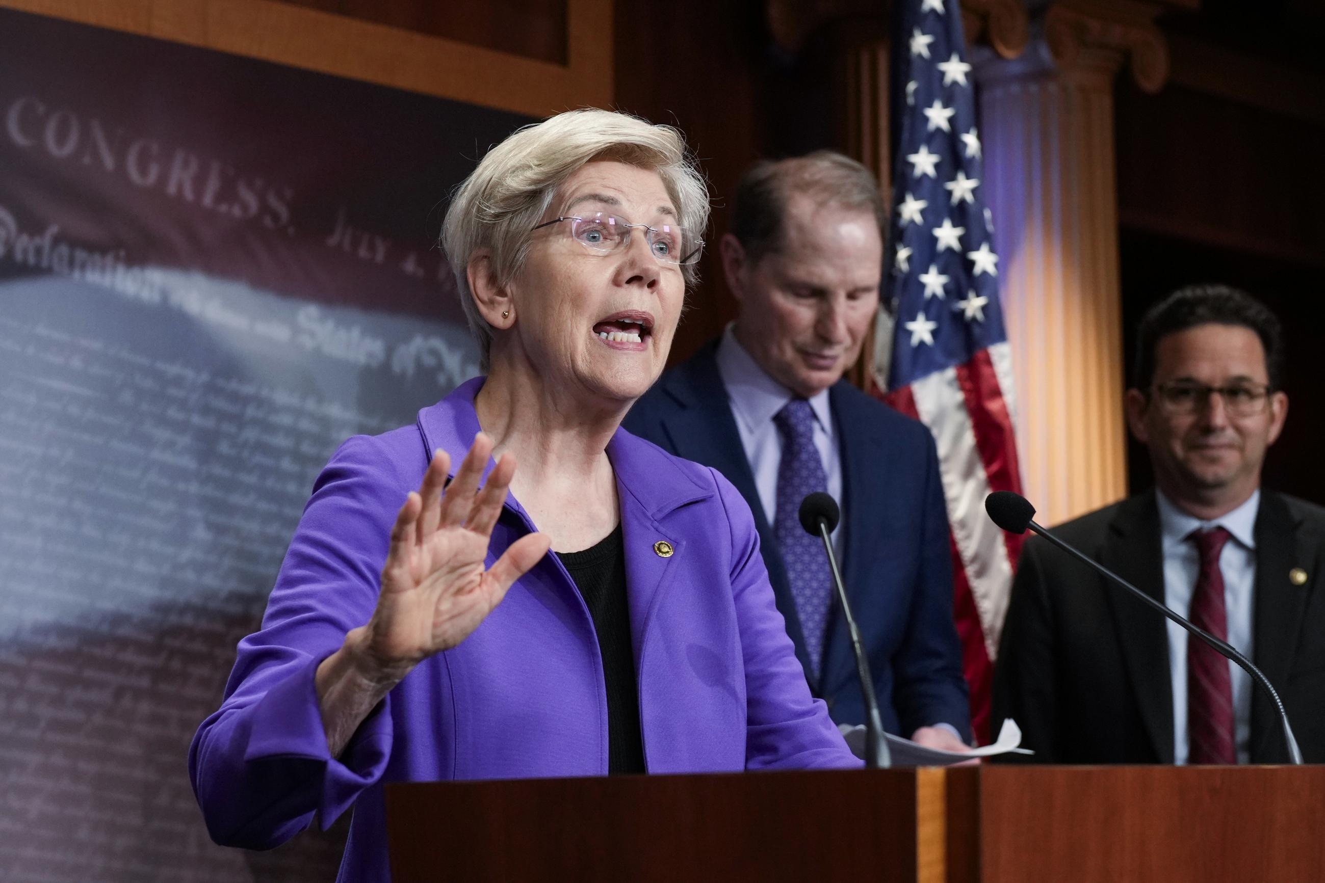 Sen. Elizabeth Warren, with Sens. Ron Wyden and Brian Schatz (AP Photo/J. Scott Applewhite)