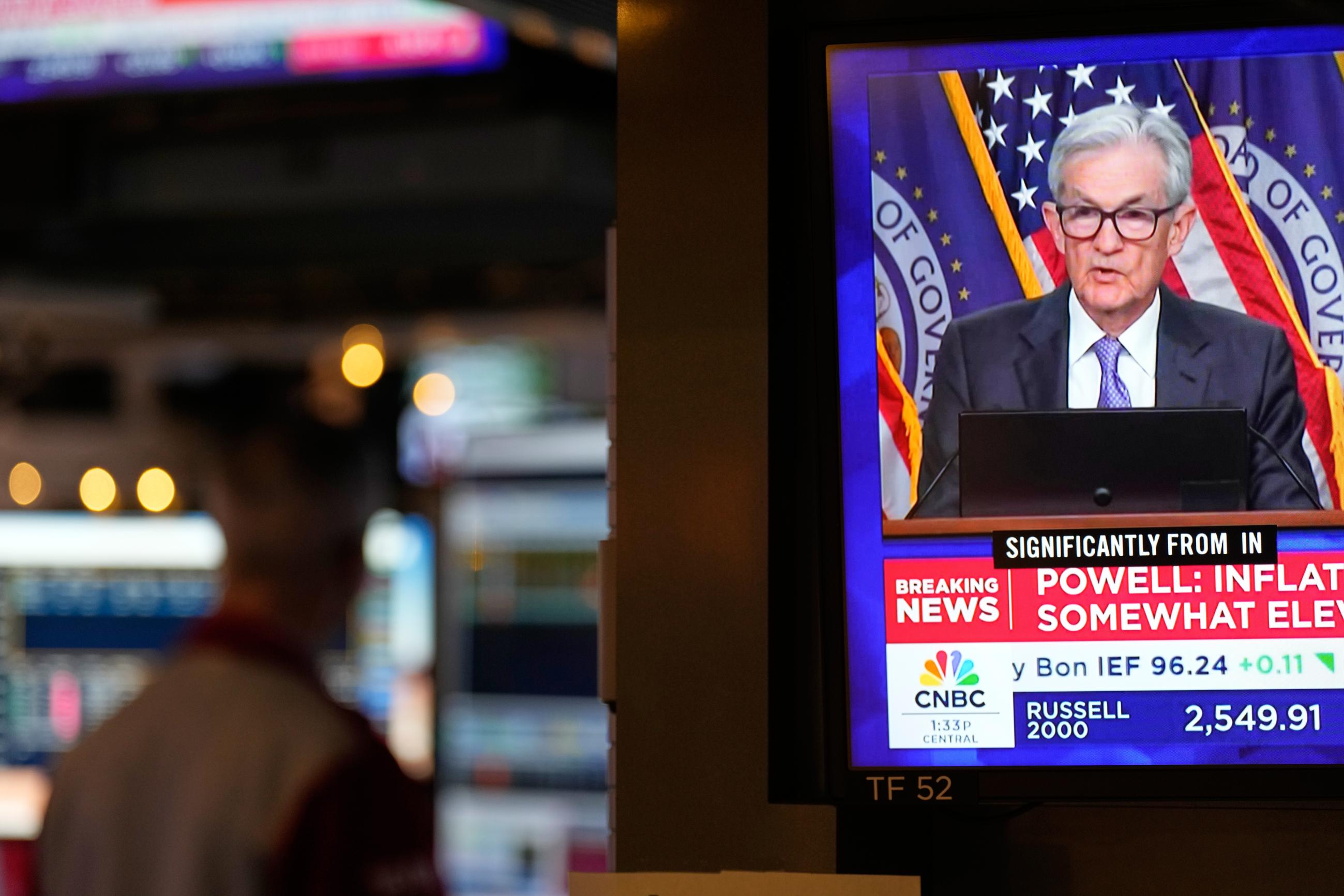 A television displays a news conference with Fed chairman Jerome Powell on the floor at the New York Stock Exchange in New York on Dec. 10. (AP Photo/Seth Wenig)