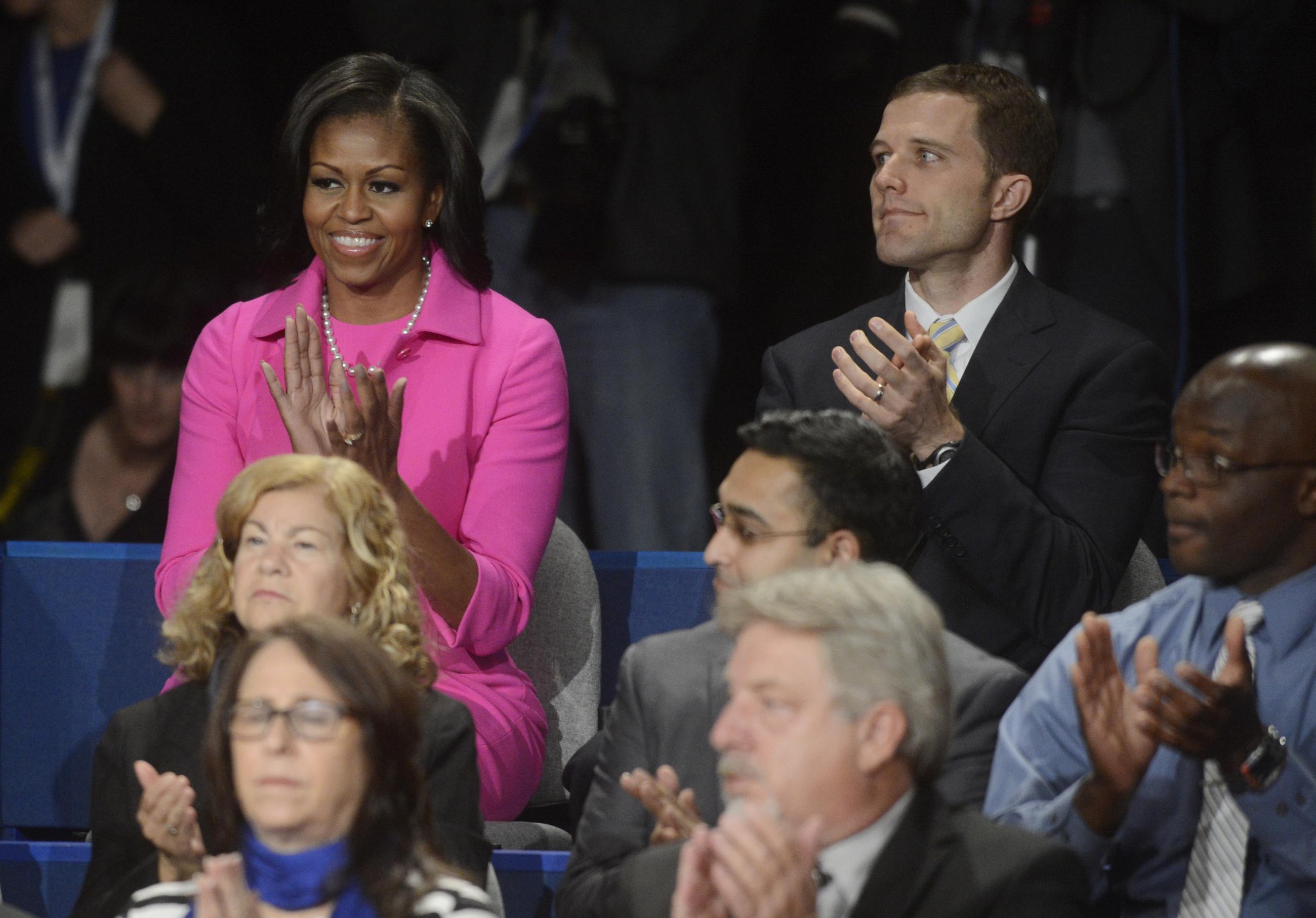 First lady Michelle Obama applauds before the start of the second presidential debate between President Barack Obama and Republican presidential nominee Mitt Romney at Hofstra University, Tuesday, Oct. 16, 2012, in Hempstead, N.Y. Seated right of Mrs. Obama is Seth Bodnar from Western Pennsylvania. (AP Photo/Pool-Michael Reynolds)