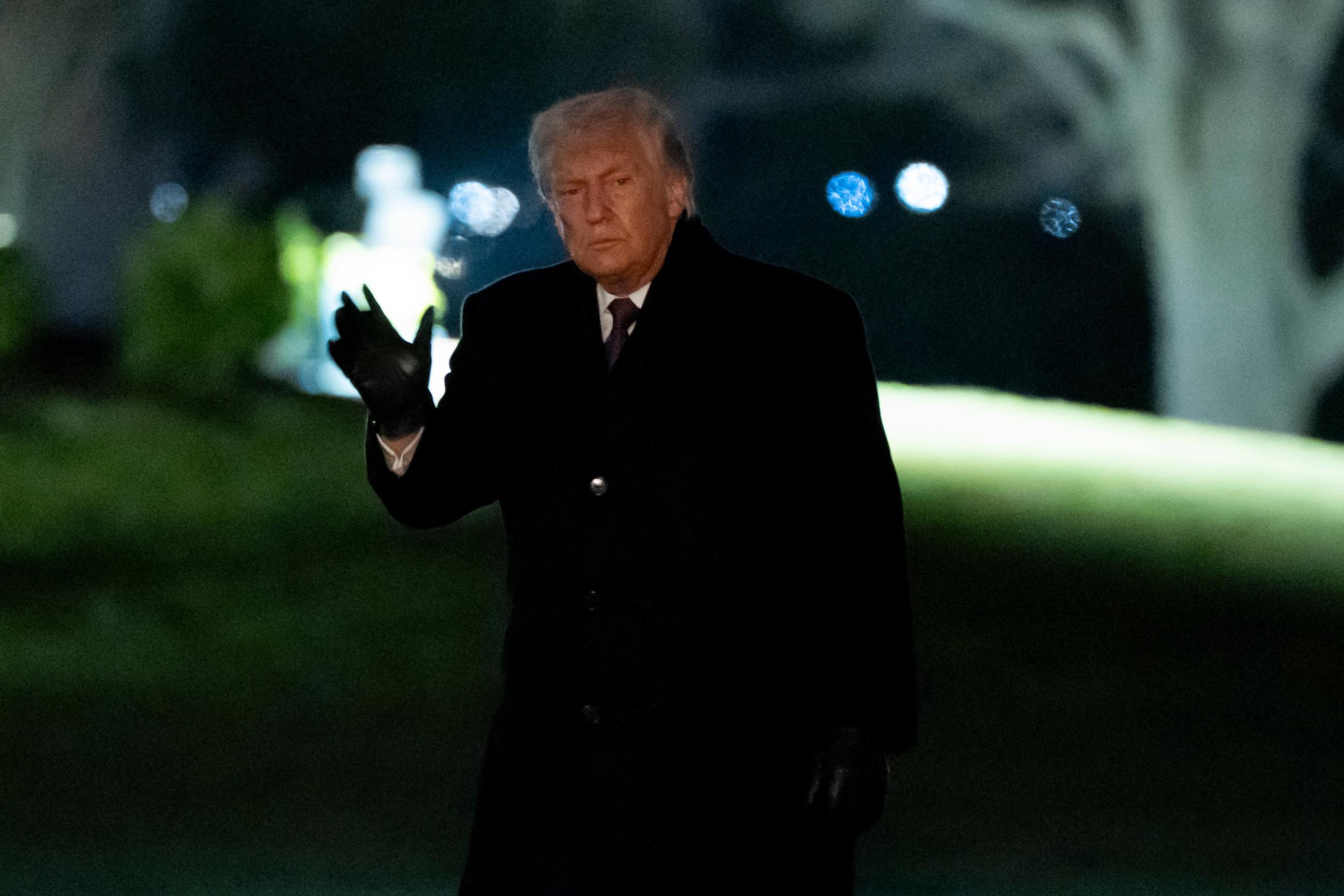 President Donald Trump waves as he walks from Marine One after arriving on the South Lawn of the White House, Thursday, Jan. 22, 2026, in Washington. (AP Photo/Alex Brandon)