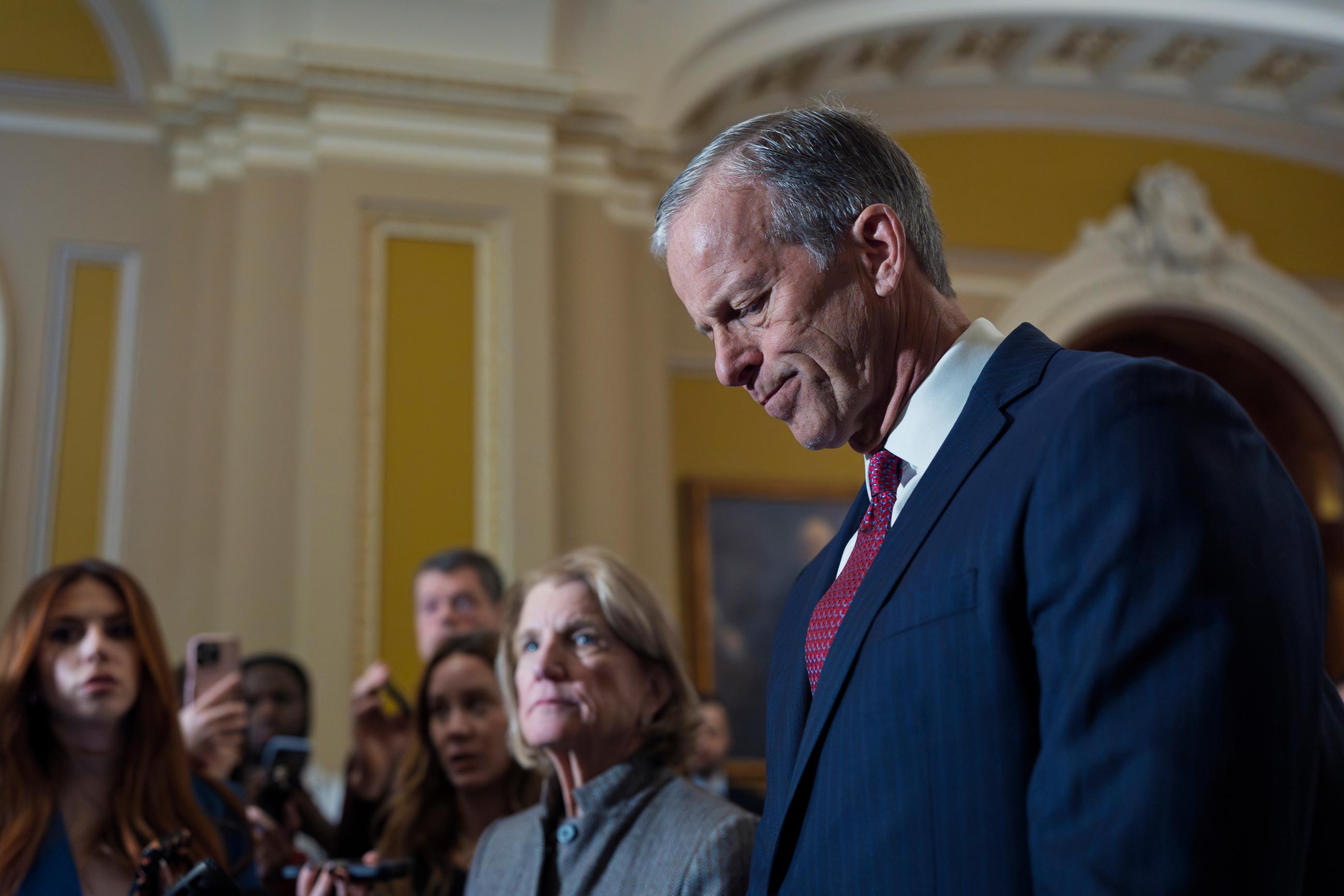 With a partial government shutdown looming by week's end, Senate Majority Leader John Thune and Sen. Shelley Moore Capito face reporters following a closed-door meeting with fellow Republicans on spending legislation Wednesday. (AP Photo/J. Scott Applewhite)