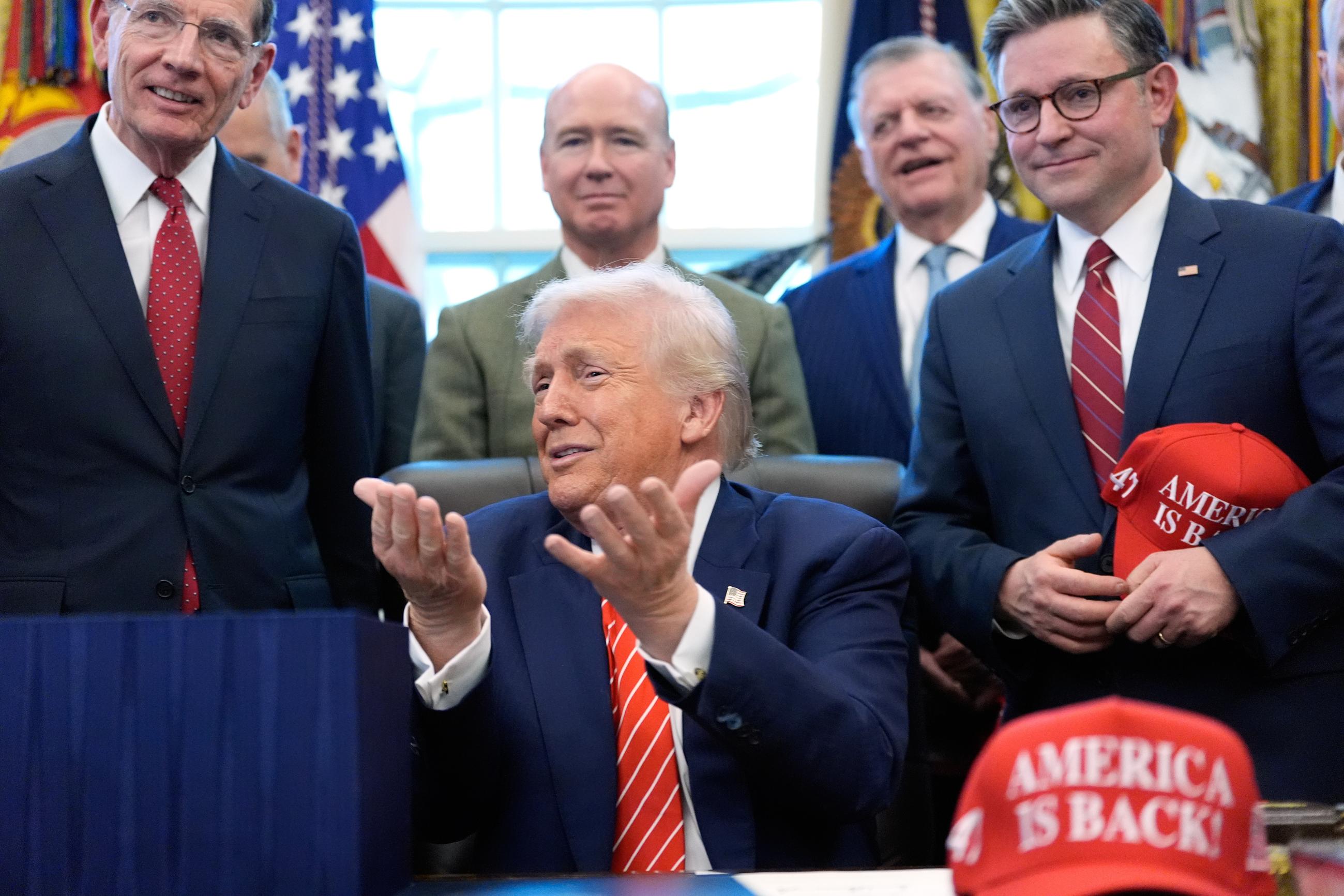 President Trump speaks to reporters after signing a spending bill that ends a partial government shutdown on Tuesday. (AP Photo/Alex Brandon)