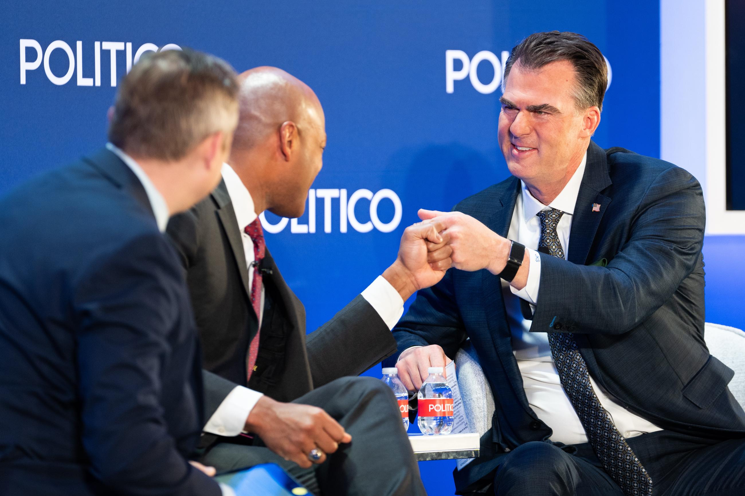 Maryland Gov. Wes Moore fist-bumps Oklahoma Gov. Kevin Stitt at an event at the National Governors Association Winter Meeting in Washington on Feb. 19. (AP Photo/Allison Robbert)