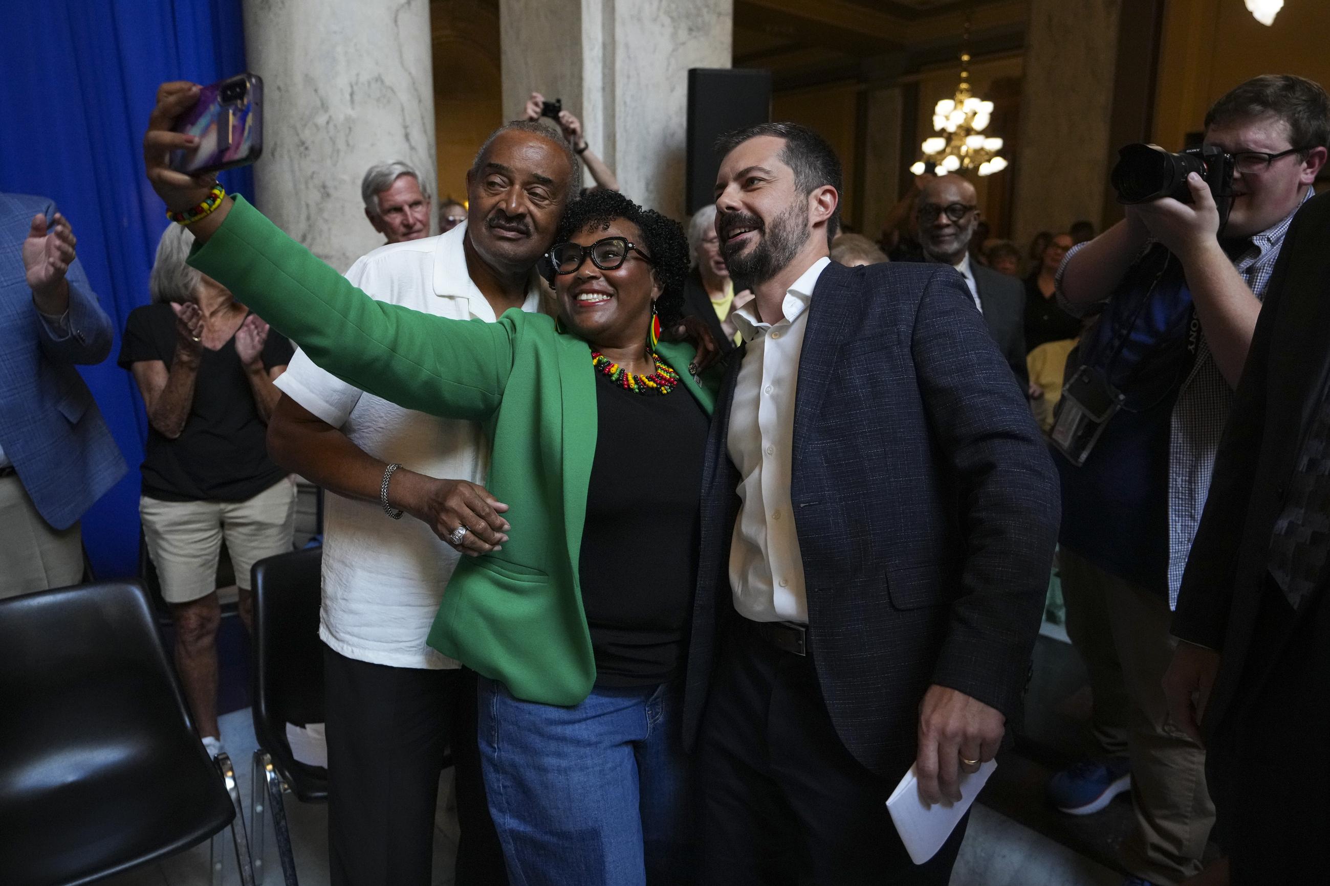 Buttigieg poses for a photo after speaking at a rally at the Indiana Statehouse in September 2025. (AP Photo/Michael Conroy)