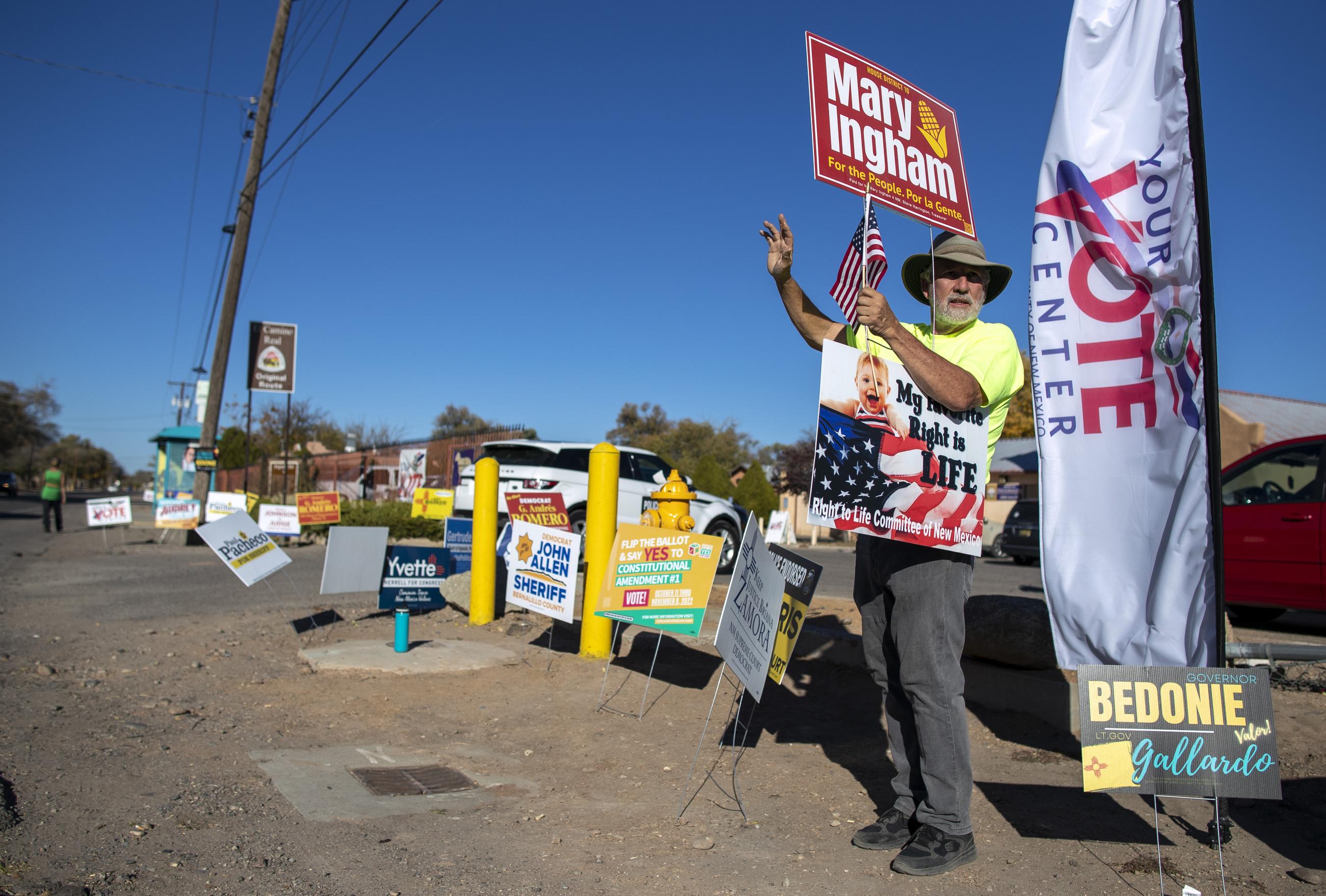 Stewart Ingham campaigning for his wife, Mary Ingham, a candidate for the New Mexico state House of Representatives, outside a polling center in the South Valley area of Albuquerque in 2022 (AP Photo/Andres Leighton)