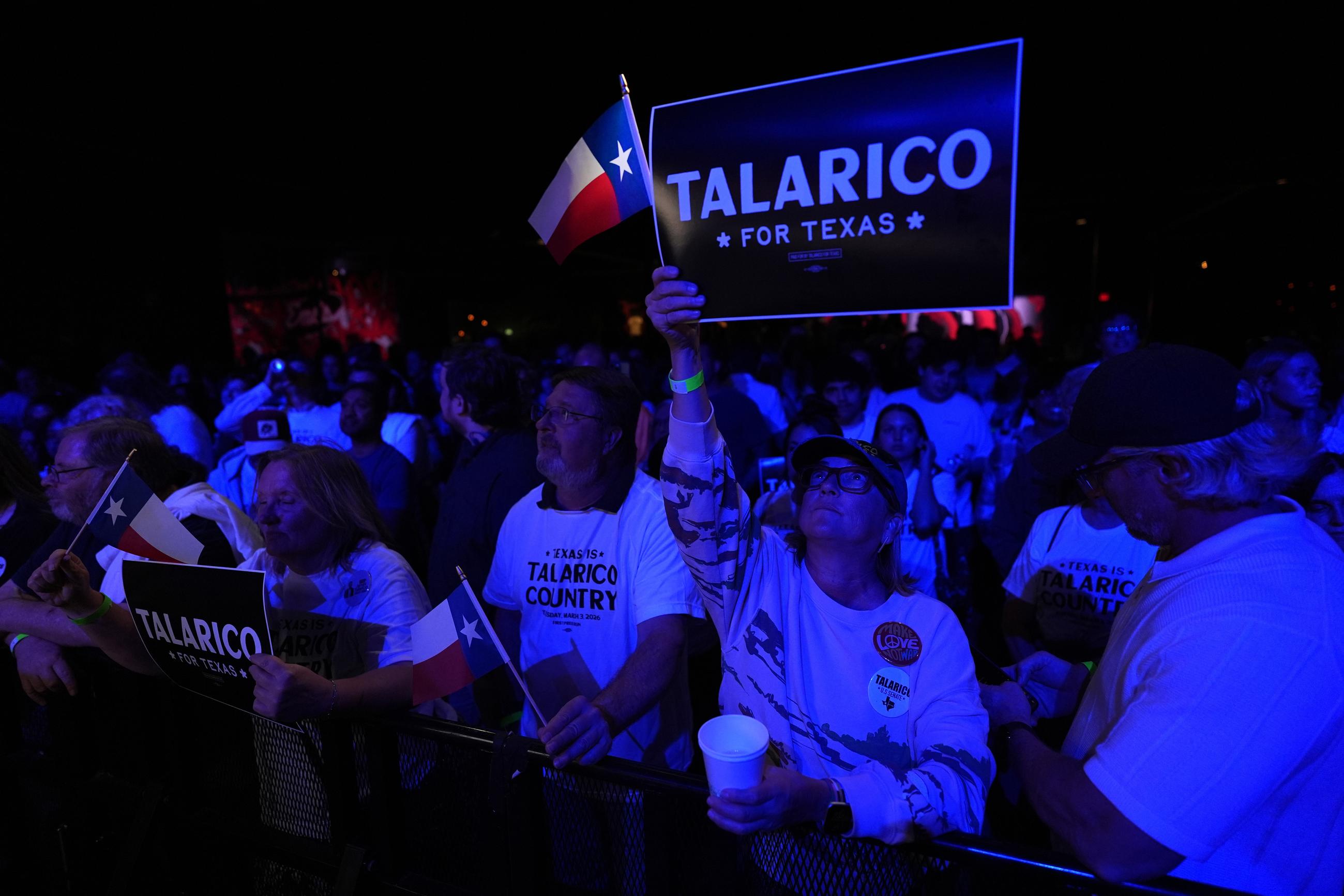 An attendee holds a Texas flag and sign before Texas Democratic Senate candidate Texas state Rep. James Talarico, D-Austin, speaks for the first time since winning the Democratic nomination in Austin, Wednesday, March 4, 2026. (AP Photo/Eric Gay)