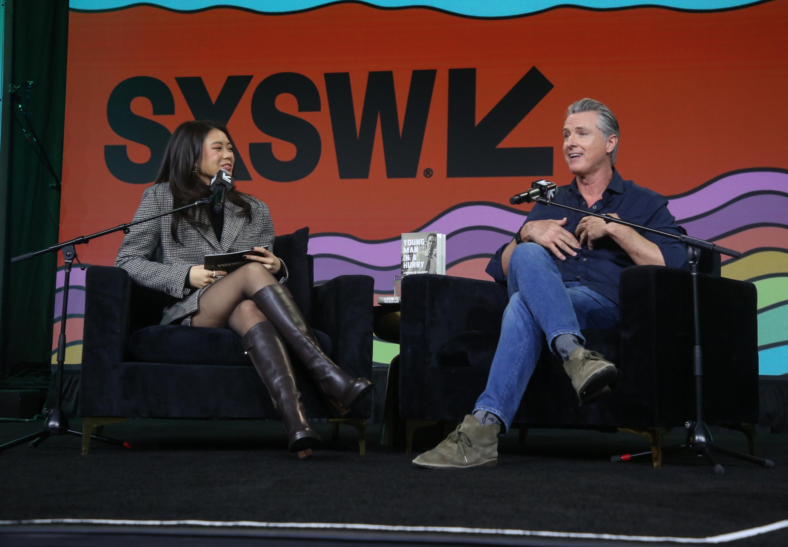 California Gov. Gavin Newsom interviewed for a podcast during a featured session at the South by Southwest Festival and Conference in Austin, Texas, on March 15 (Photo by Jack Plunkett/Invision/AP)