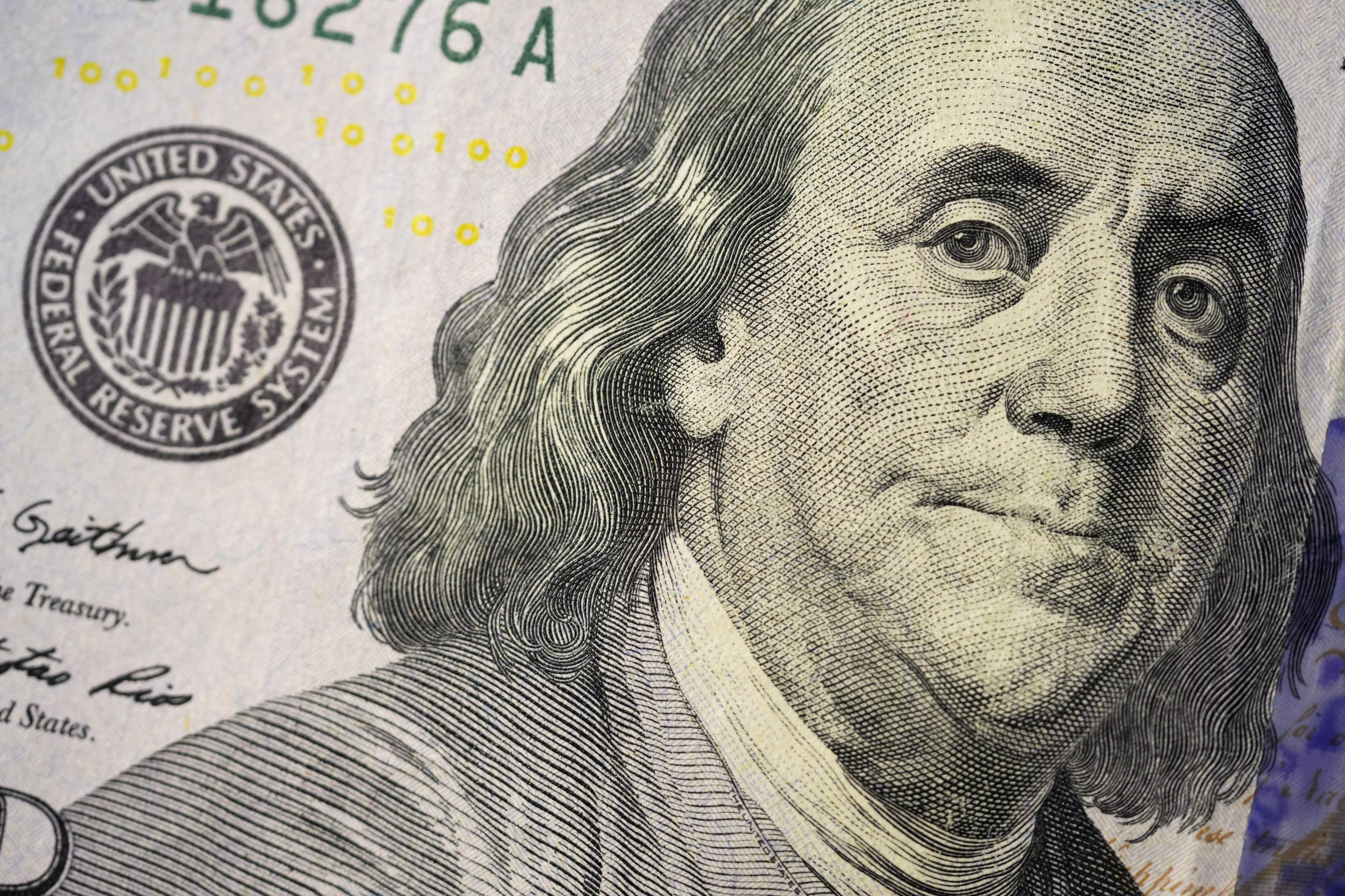 The likeness of Benjamin Franklin is seen on a U.S. $100 bill. (AP Photo/Matt Slocum)